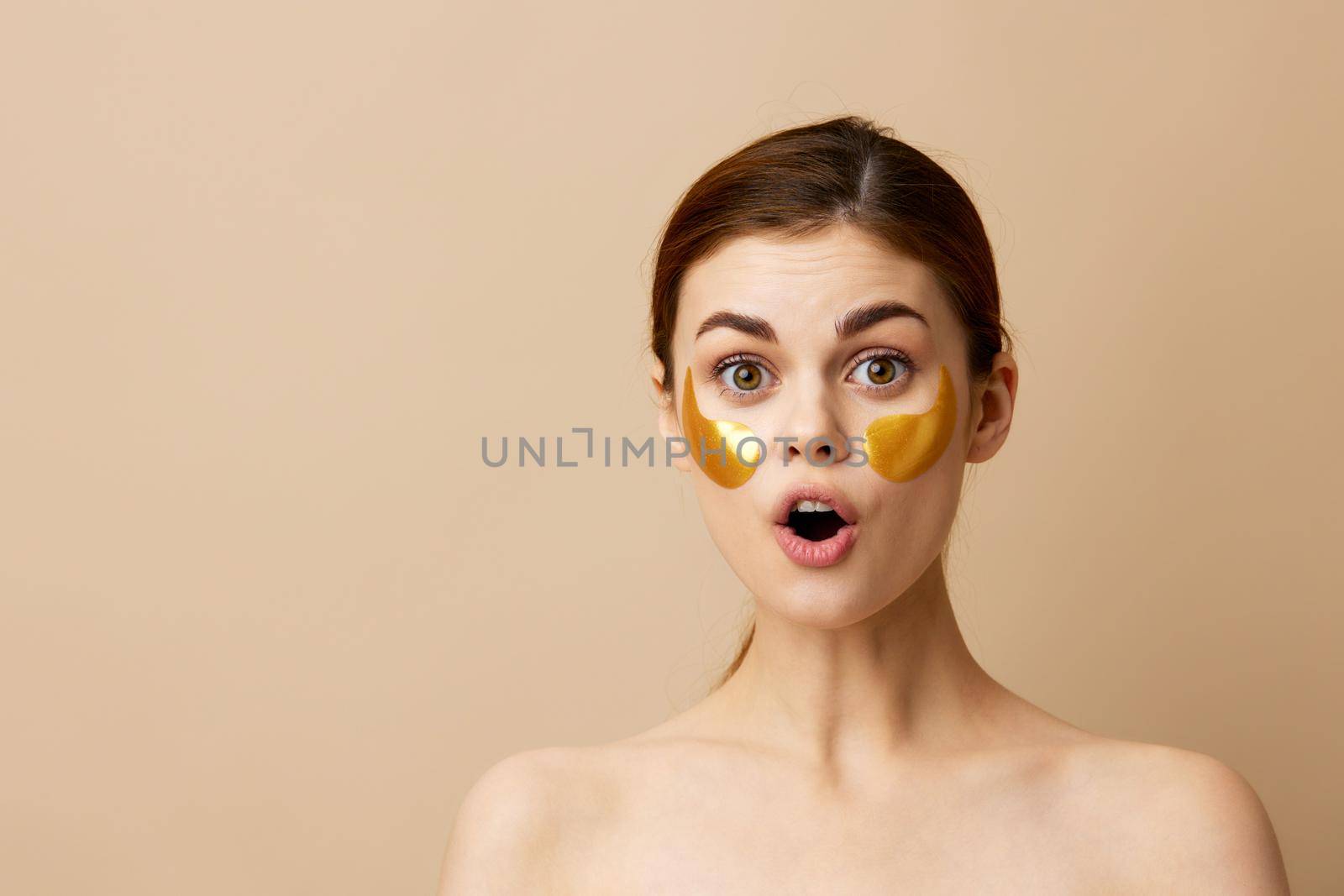 pretty woman skin care face patches bare shoulders hygiene close-up Lifestyle. High quality photo