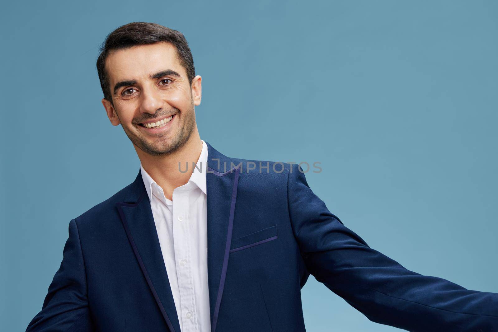 portrait businessman in a blue suit gesticulates with hands cropped view. High quality photo