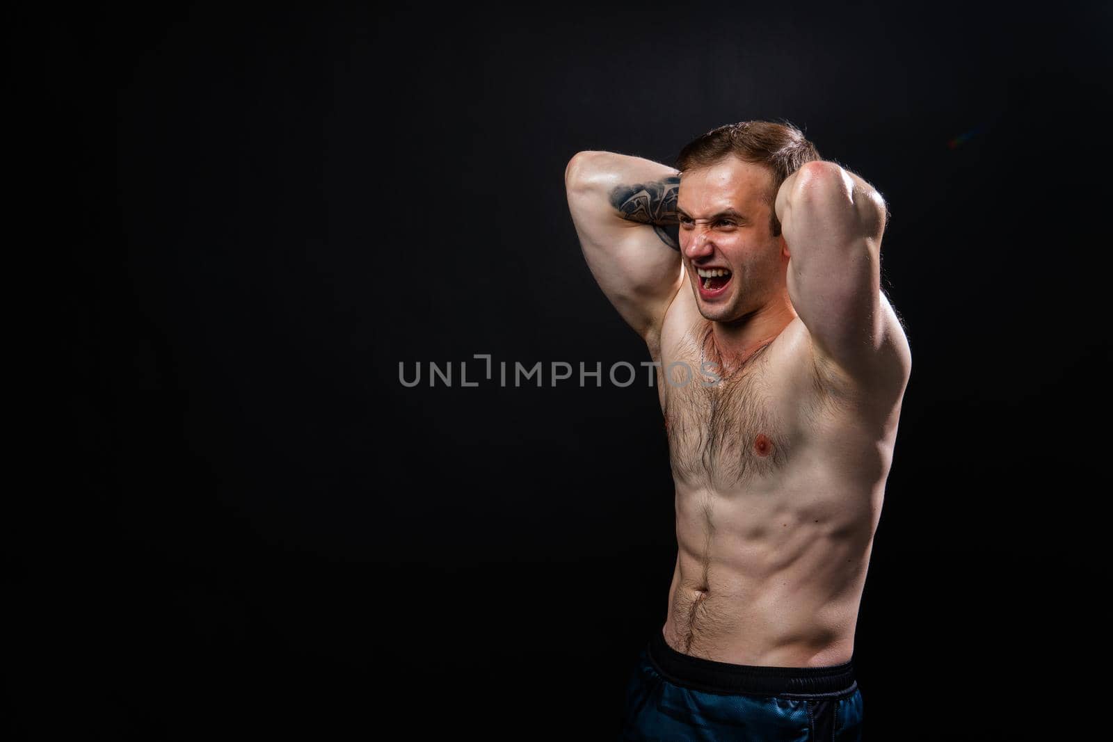 Man on black background keeps dumbbells pumped up in fitness bodybuilding sexy athlete exercise hand, person pectoral. Attractive skin metal, human fit hands behind your head a beautiful press