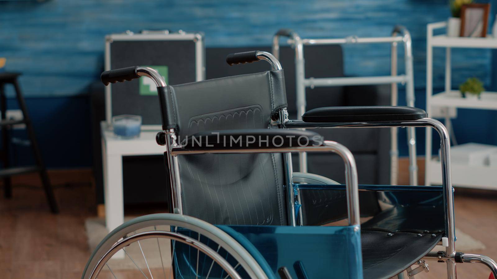 Close up of wheelchair for mobility and transportation in nursing home. Medical chair used for stationary and disabled people, supporting with handicap. Invalidity object in empty room