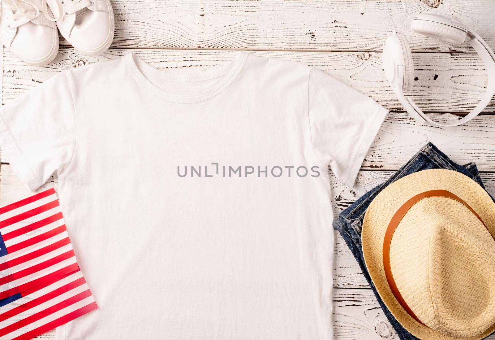 Mockup design white t shirt for logo, top view on white wooden background with US flag and decoration by Desperada
