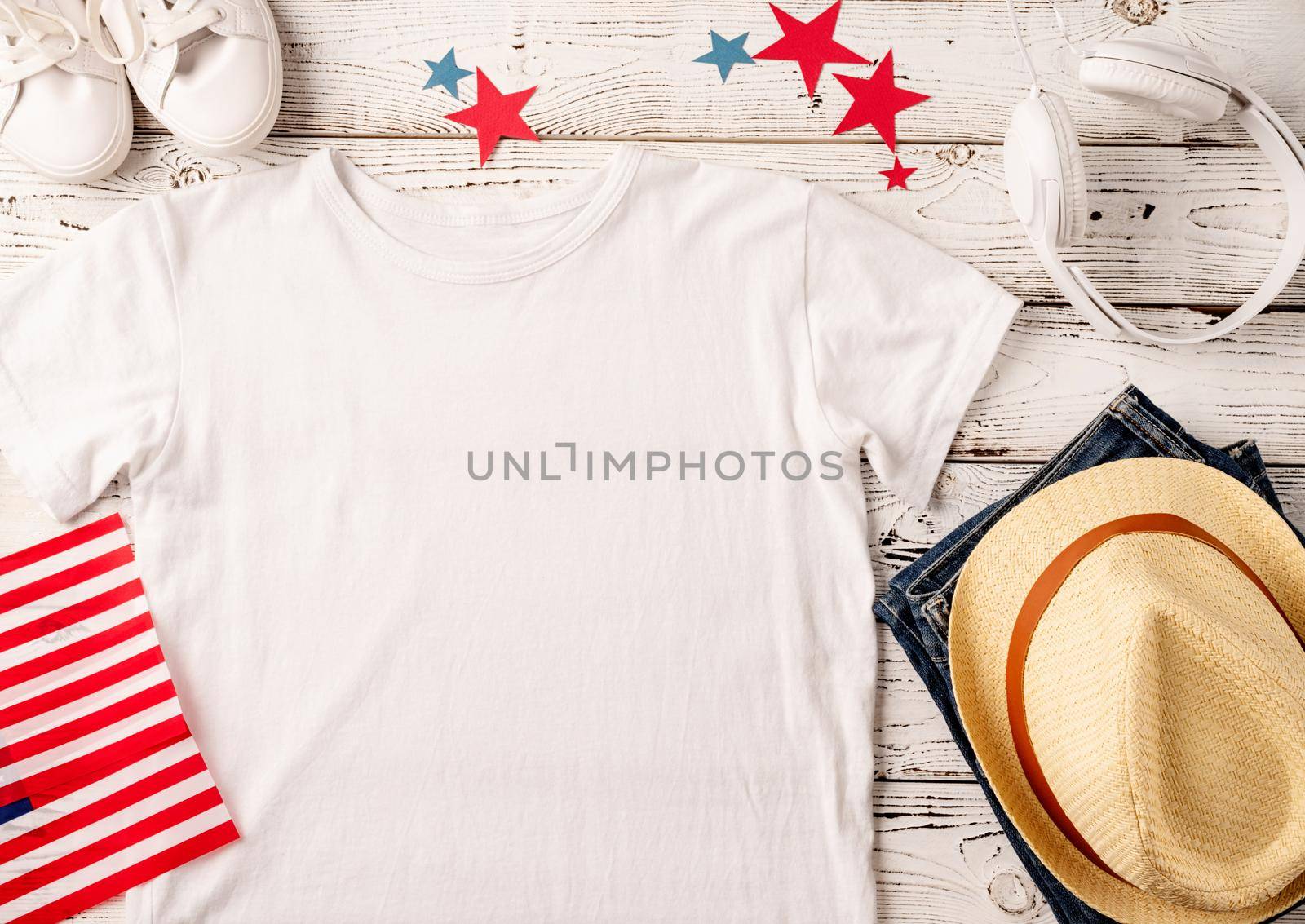 USA Memorial day, Presidents day, Veterans day, Labor day, or 4th of July celebration. Mockup design polo t shirt for logo, top view on white wooden background with US flag and jeans