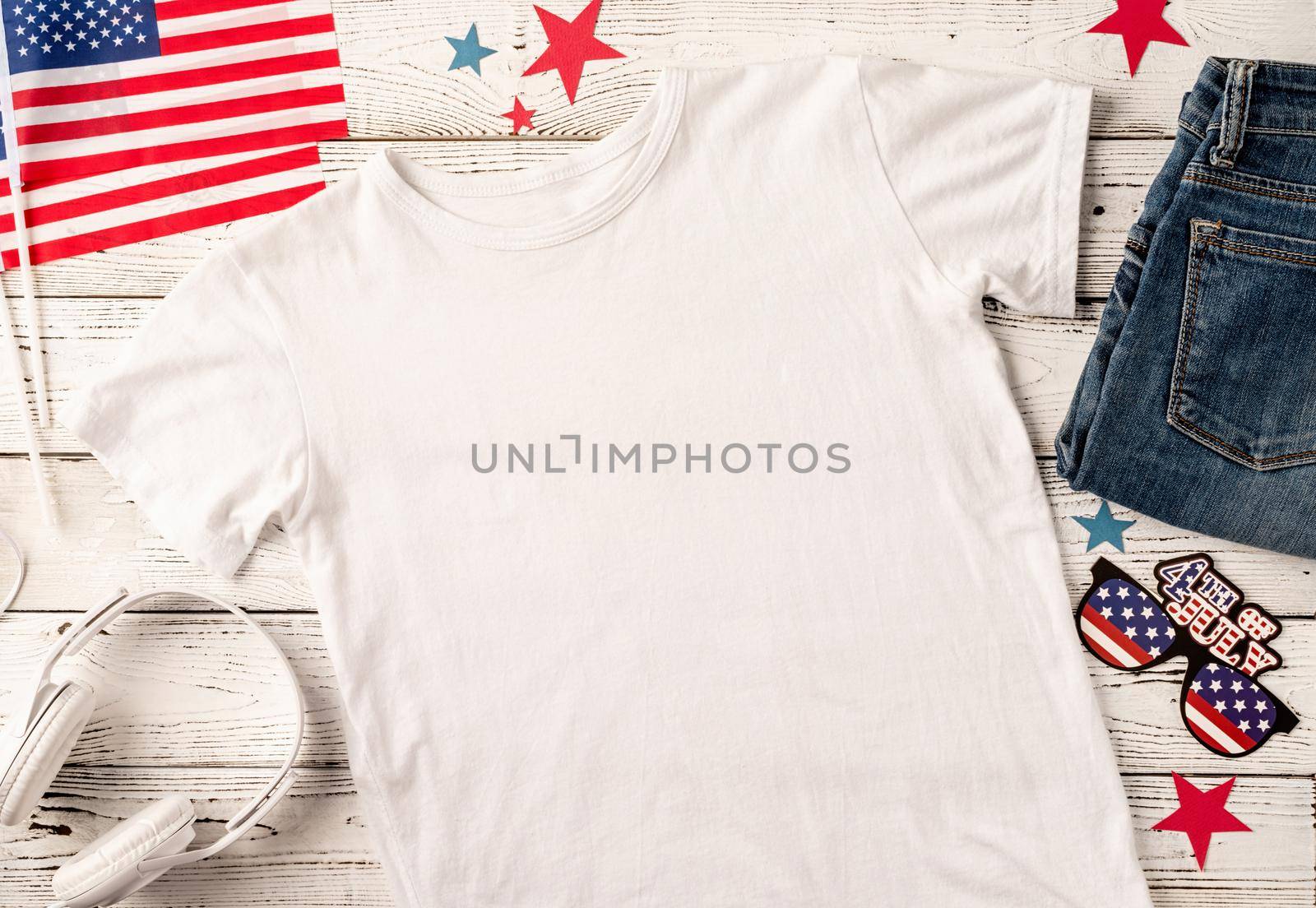 USA Memorial day, Presidents day, Veterans day, Labor day, or 4th of July celebration. Mockup design polo t shirt for logo, top view on white wooden background with US flag, shoes and jeans