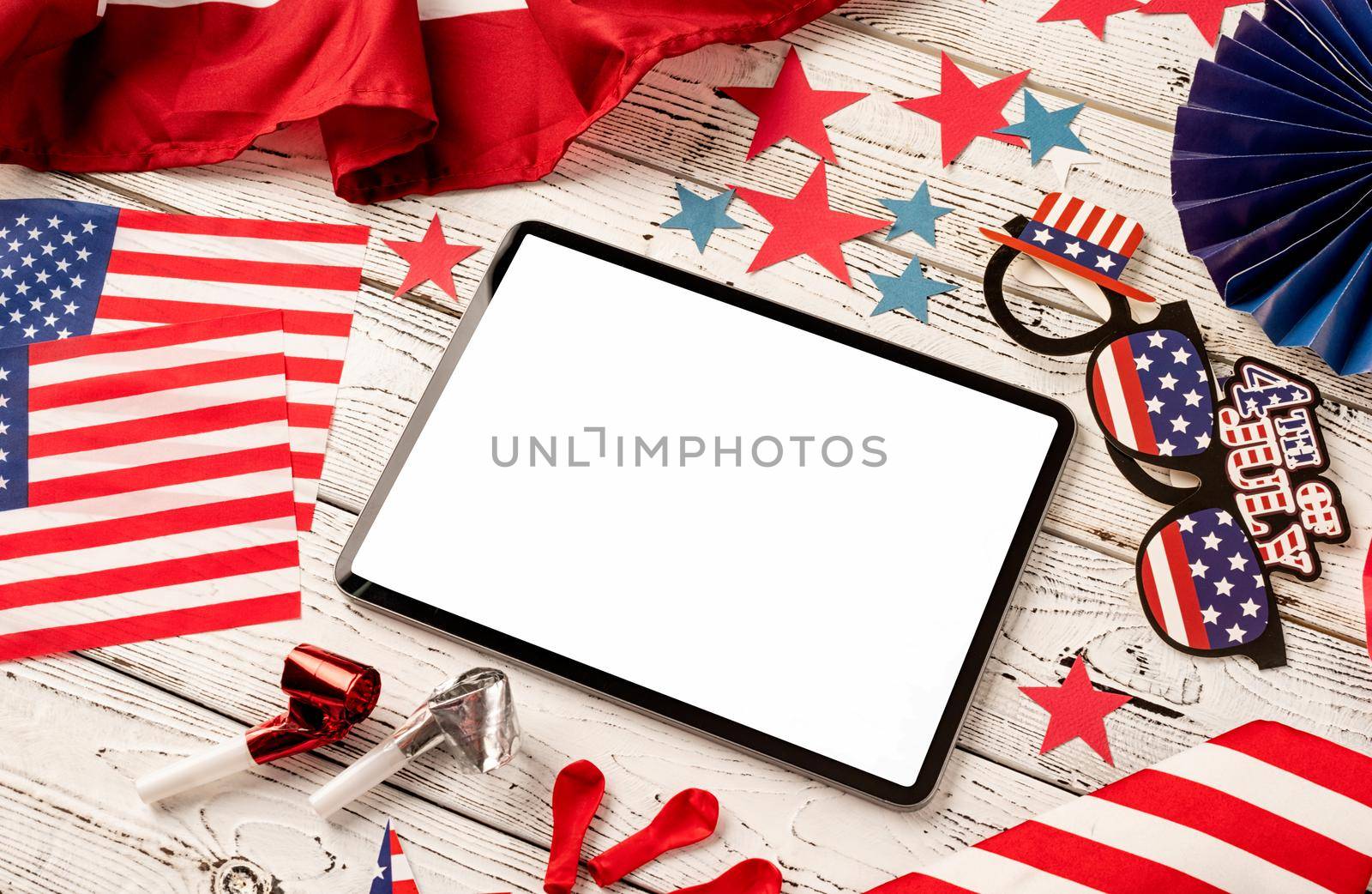 USA Memorial day, Presidents day, Veterans day, Labor day, or 4th of July celebration. Digital tablet with white screen for mockup design surrounded with independence day party element