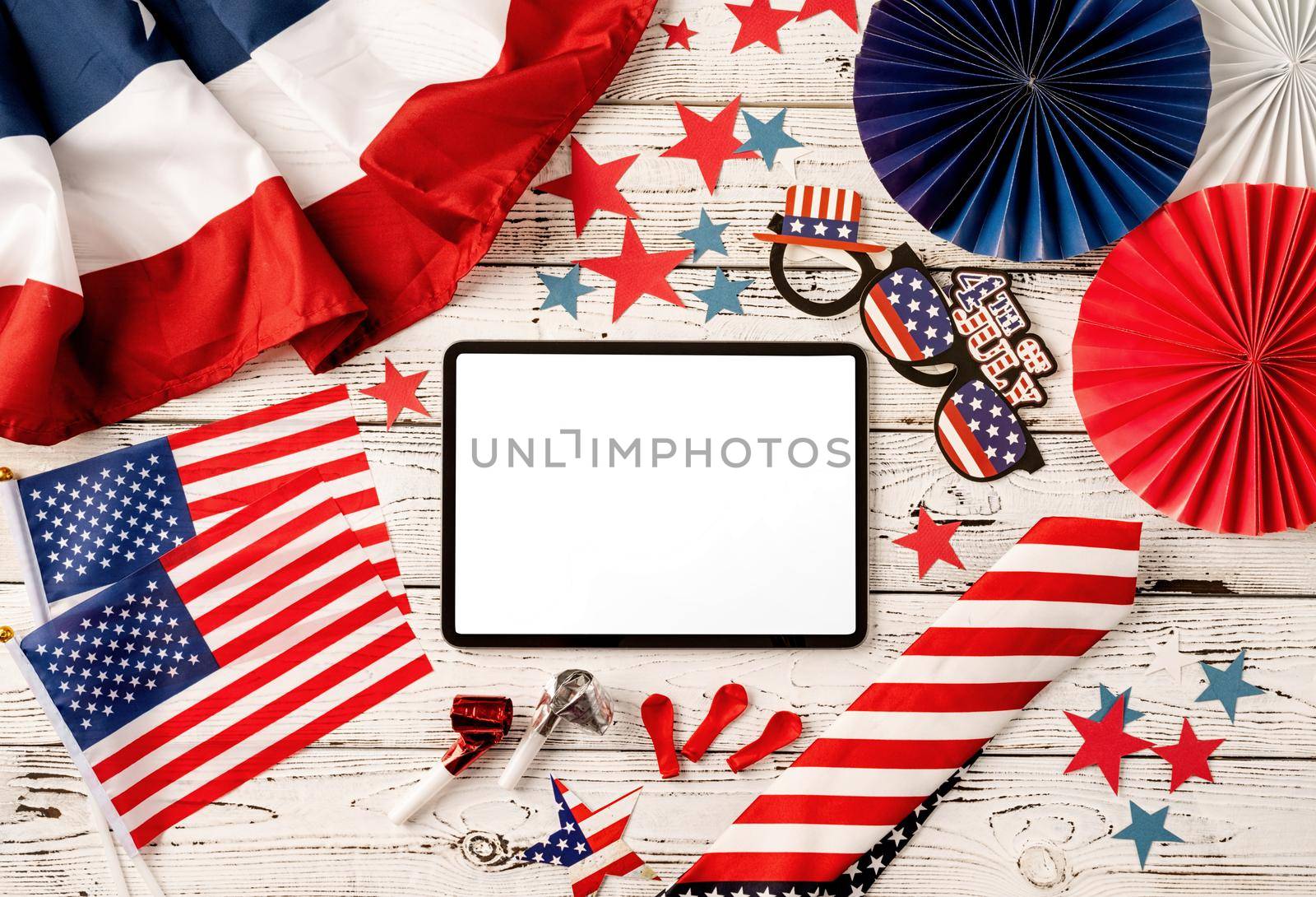 USA Memorial day, Presidents day, Veterans day, Labor day, or 4th of July celebration. Digital tablet with white screen for mockup design surrounded with independence day party element top view flat lay