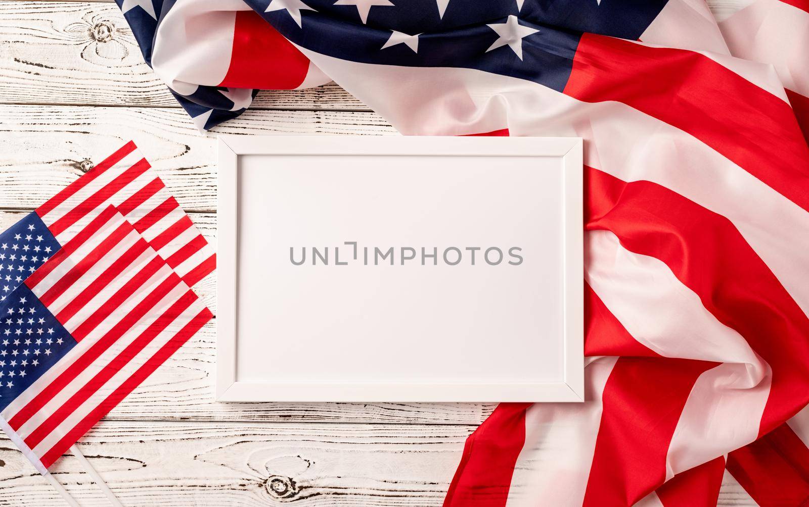 USA Memorial day, Presidents day, Veterans day, Labor day, or 4th of July celebration. Blank white photo frame for mockup design on American national flag wooden background