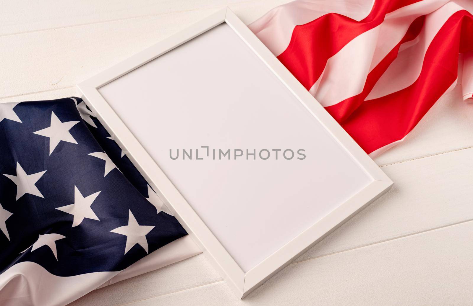 Blank white photo frame for mockup design on American national flag white background by Desperada