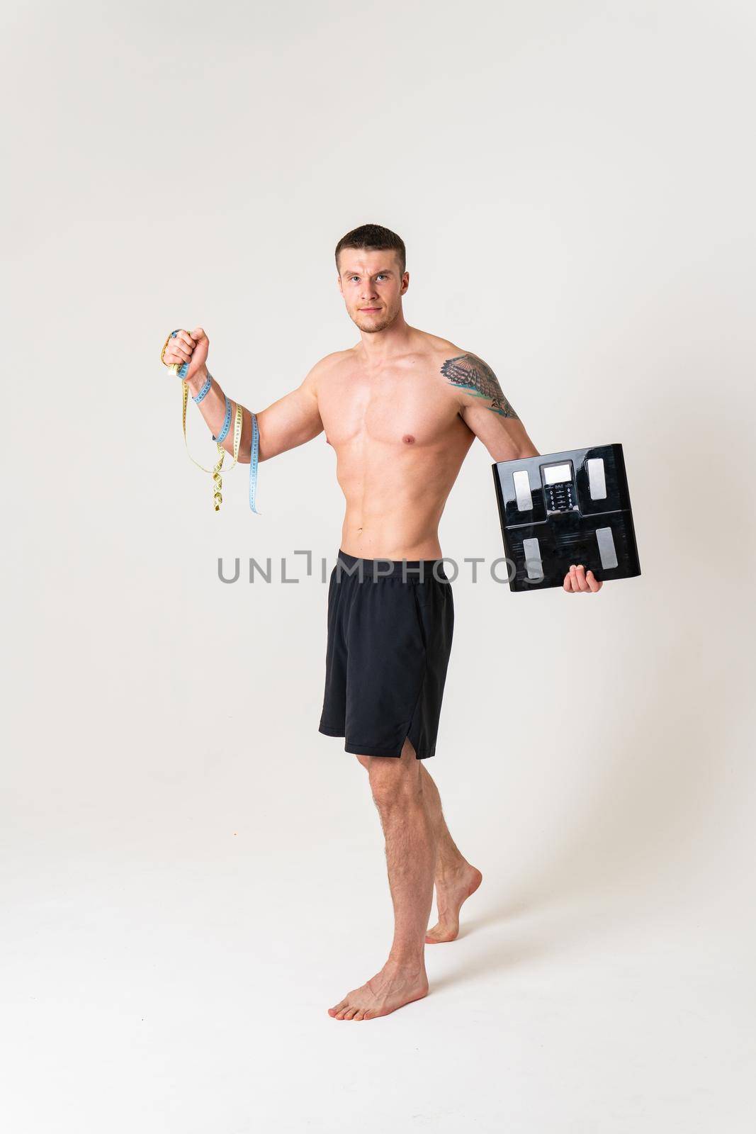 Man with weights health pondered, health and sports on a white background back body ill sick man health stress, muscular chronic. lumbar therapy, problem suffer attractive