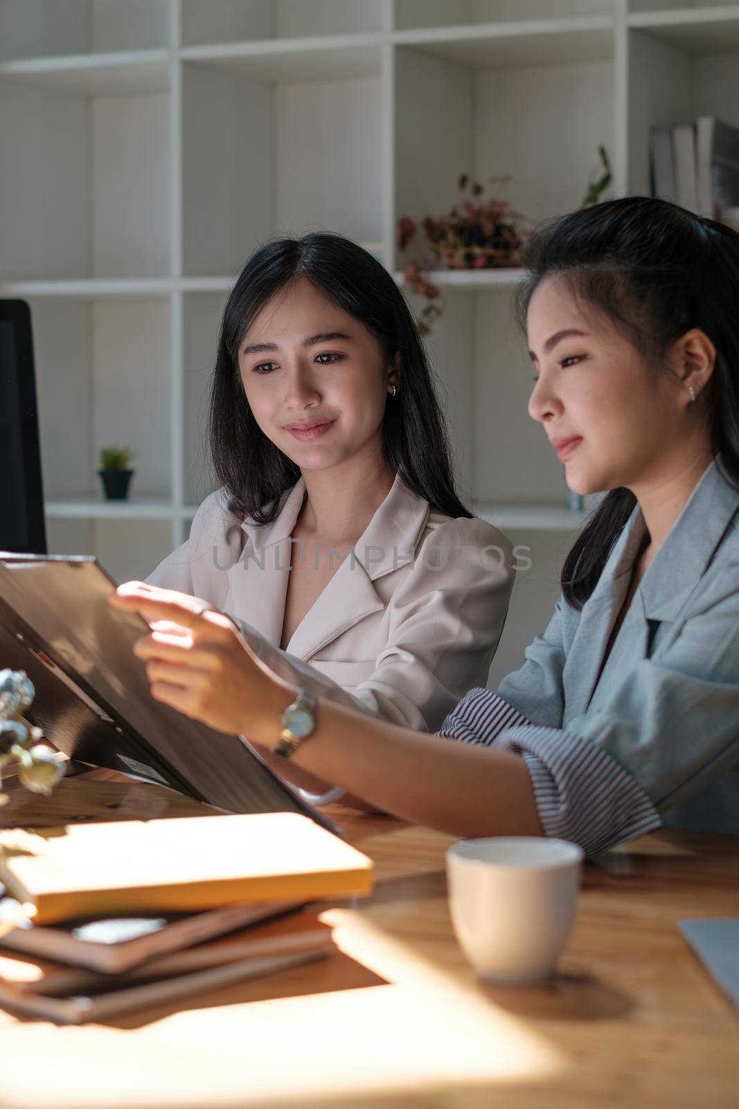 Group of Businesswoman and Accountant checking data document on digital tablet for investigation of corruption account . Anti Bribery concept. by itchaznong