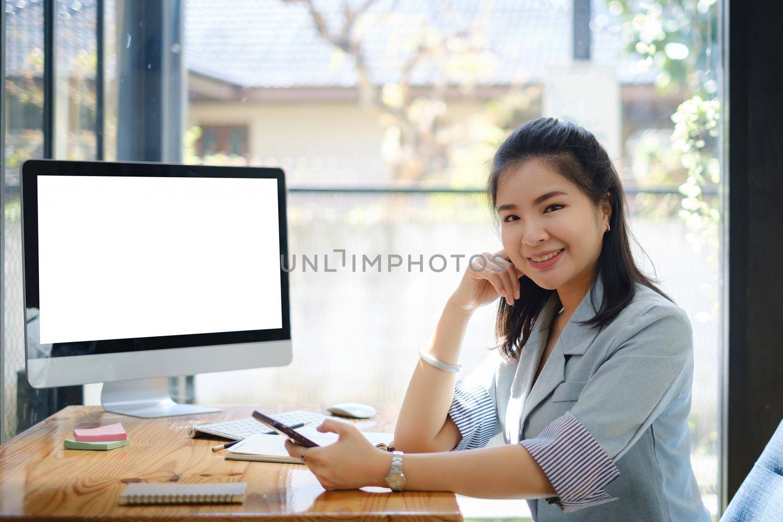 Business Finance and Accounting Concept. Business woman using cell phone at office