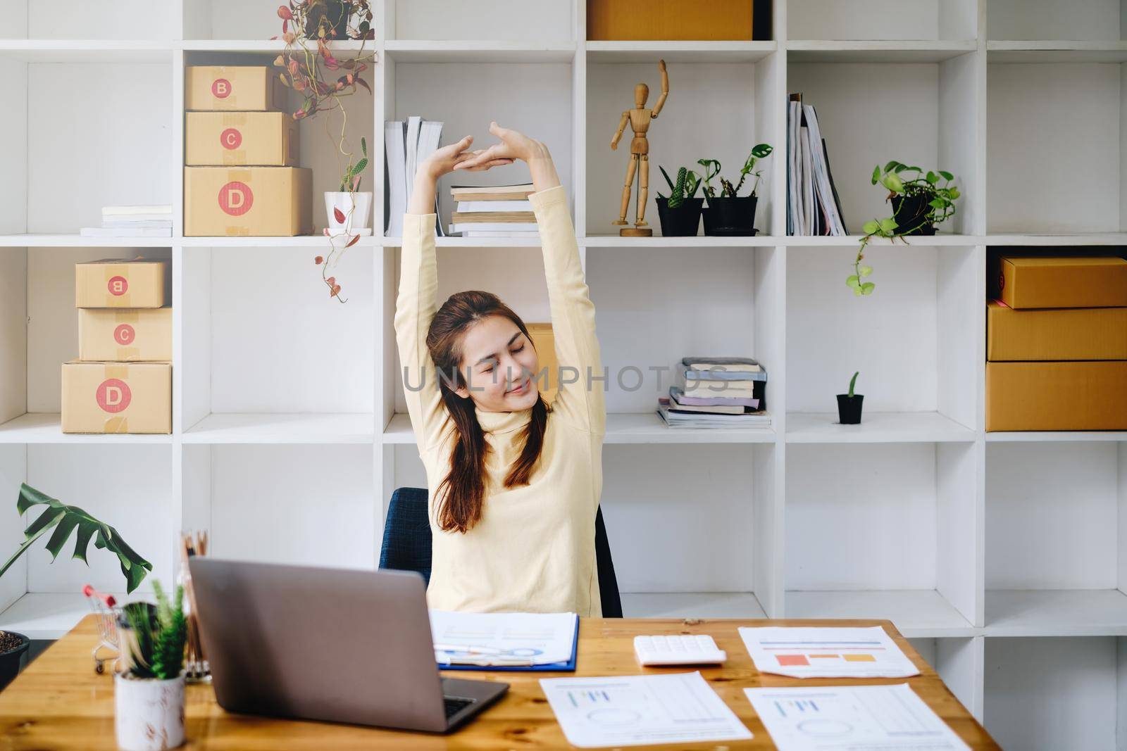 Asian business woman relaxing on table after hard work to audit transactions account budget of company. Accountant and Anti Bribery concept