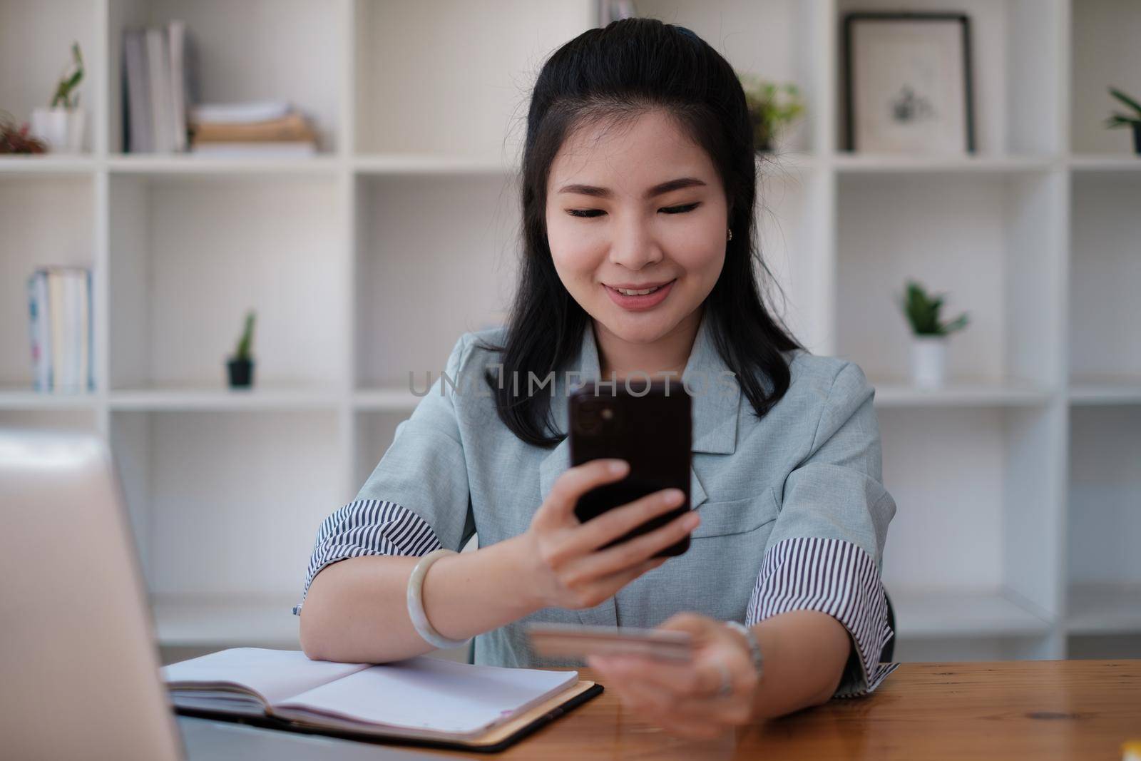Woman enjoy with online shopping application and typing credit card for fill number to payment with virtual digital asset and metaverse