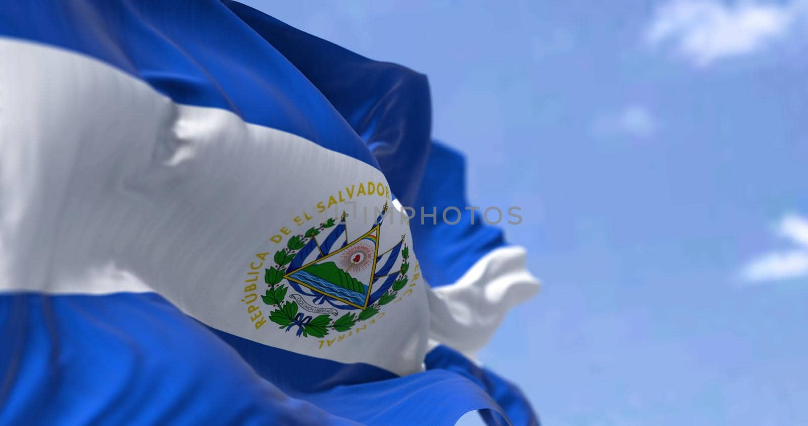 Detail of the national flag of El Salvador waving in the wind on a clear day by rarrarorro