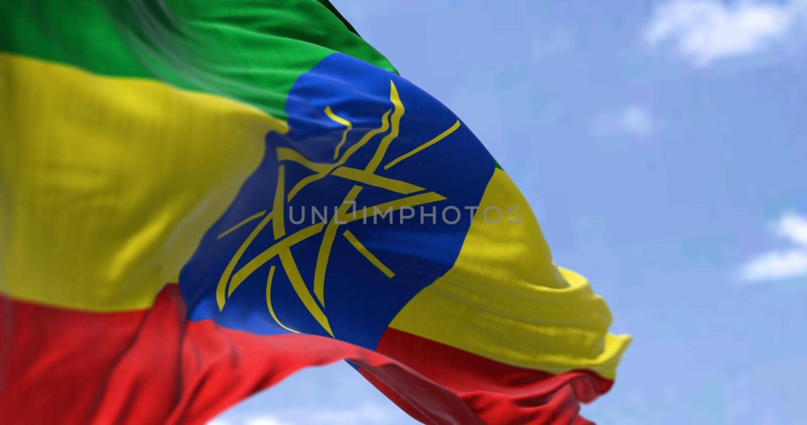 Detail of the national flag of Ethiopia waving in the wind on a clear day. by rarrarorro
