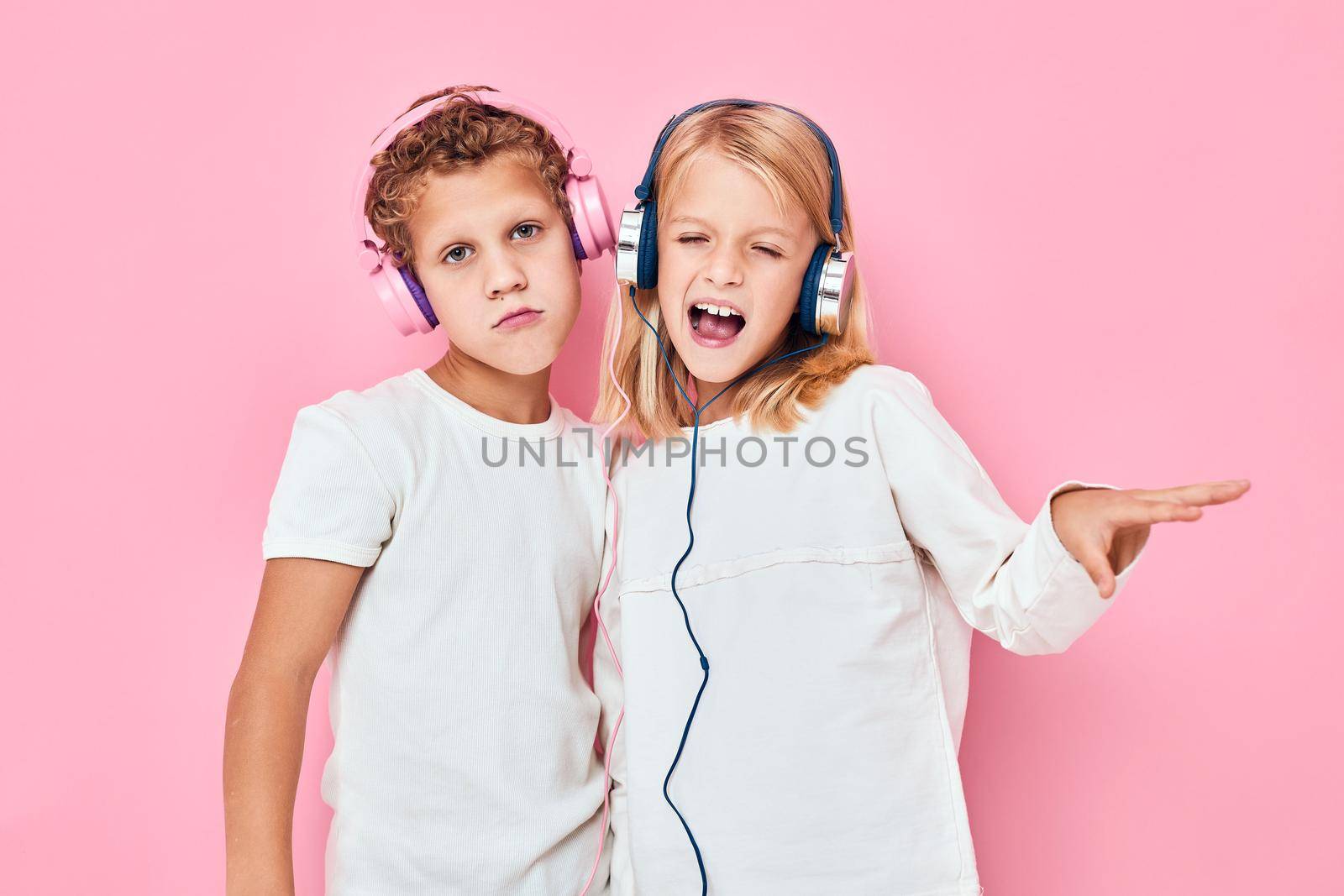 boy and girl dancing with headphones entertainment lifestyle childhood. High quality photo