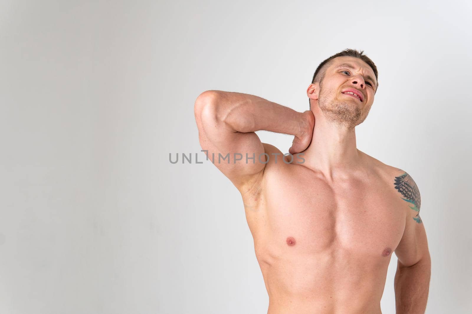 The muscles of the neck in a man on a white background are hurt ache body muscle, sick medicine, human expression. Touching lumbar therapy, back suffer attractive