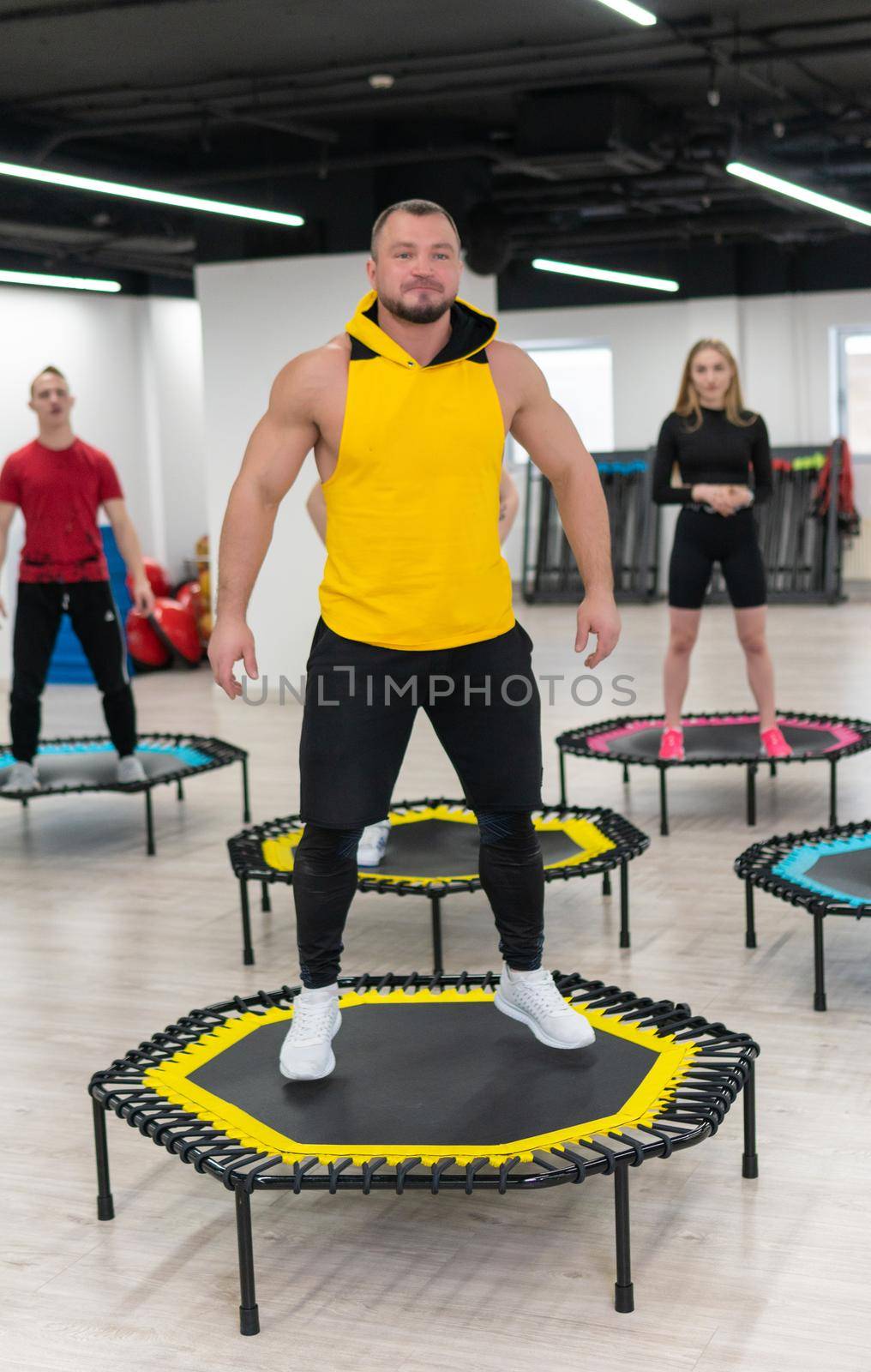 Women's and men's group on a sports trampoline, fitness training, healthy life - a concept trampoline group batut instructor health, from female athletic from training for exercise person, sportive beautiful. Many bodycare athlete, exercising