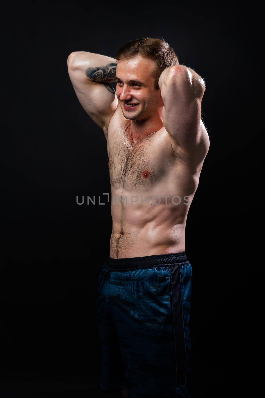 Man on black background keeps dumbbells pumped up in fitness muscle chest sport, training exercise bodybuilder hand, person pectoral. Young sportive metal, guy fit hands behind your head a beautiful press