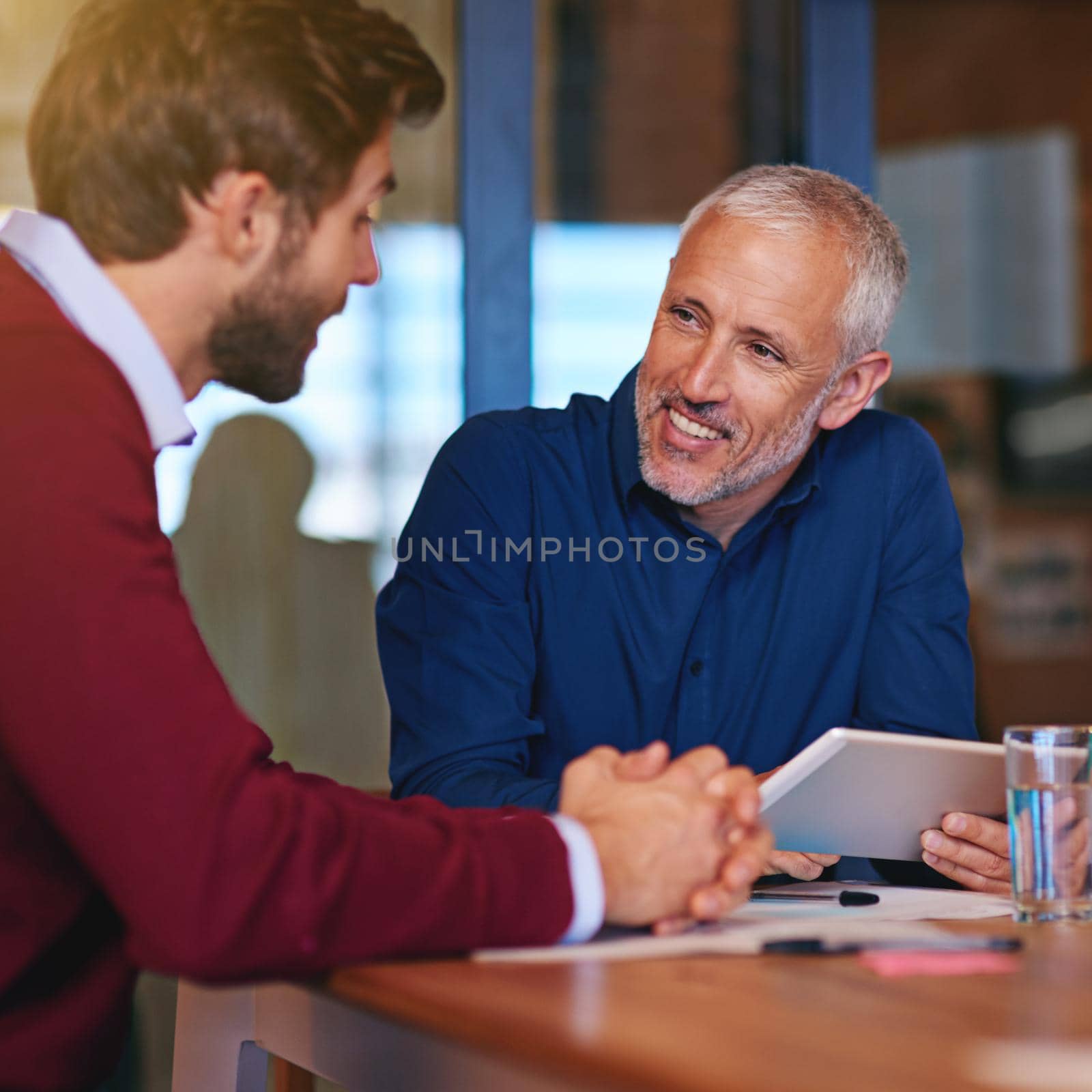 Shot of two businessmen having a meeting in an office.