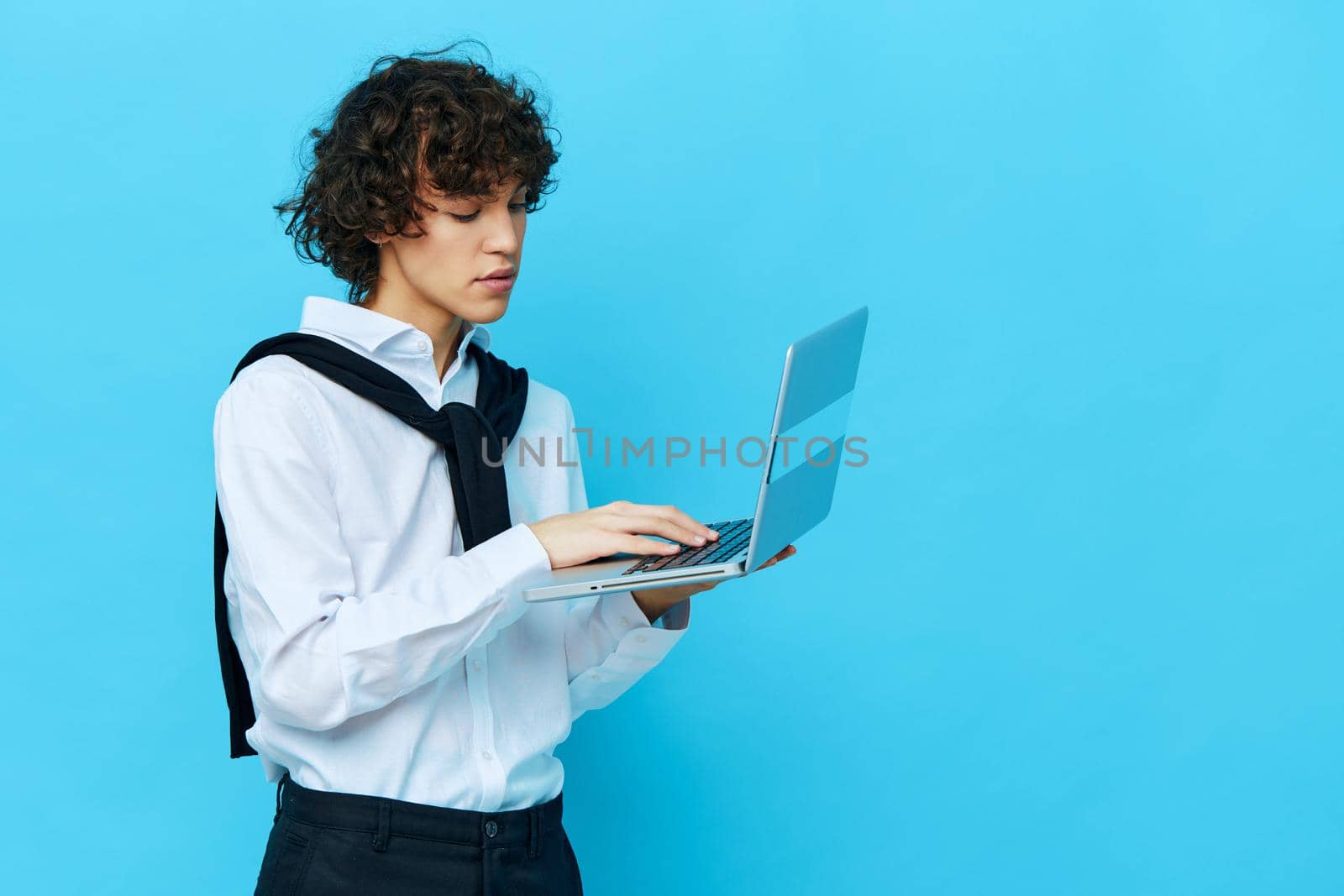 student with laptop internet in a white shirt with a sweater cropped view. High quality photo