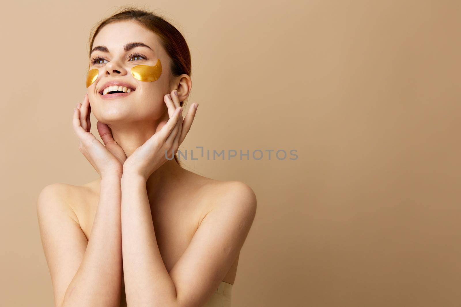 woman golden patches clean skin smile posing beige background. High quality photo