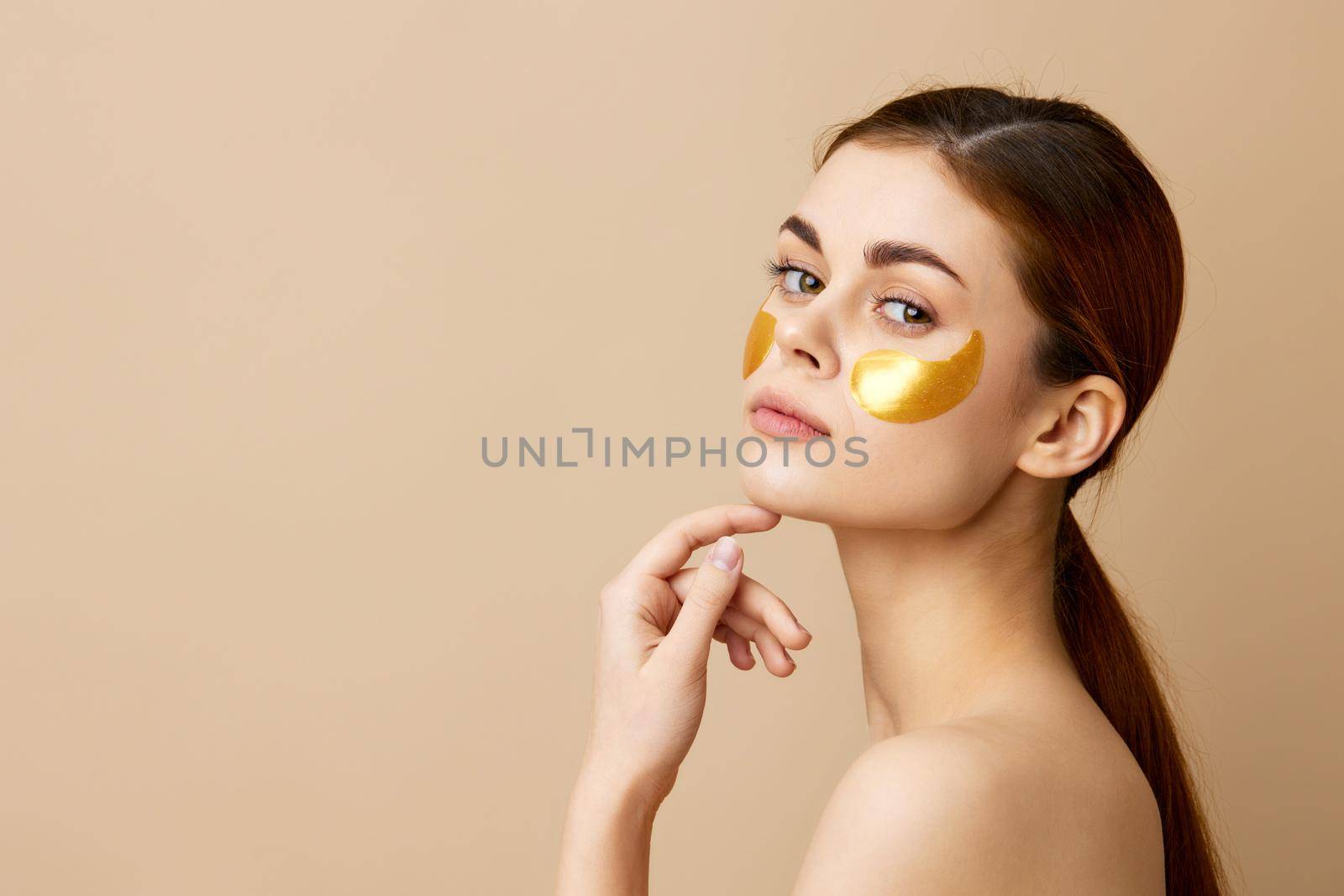 woman golden patches clean skin smile posing beige background by SHOTPRIME