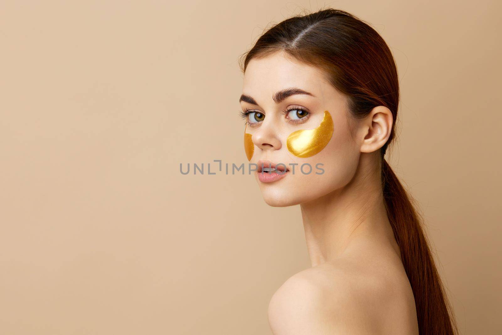 portrait woman skin care face patches bare shoulders hygiene beige background by SHOTPRIME