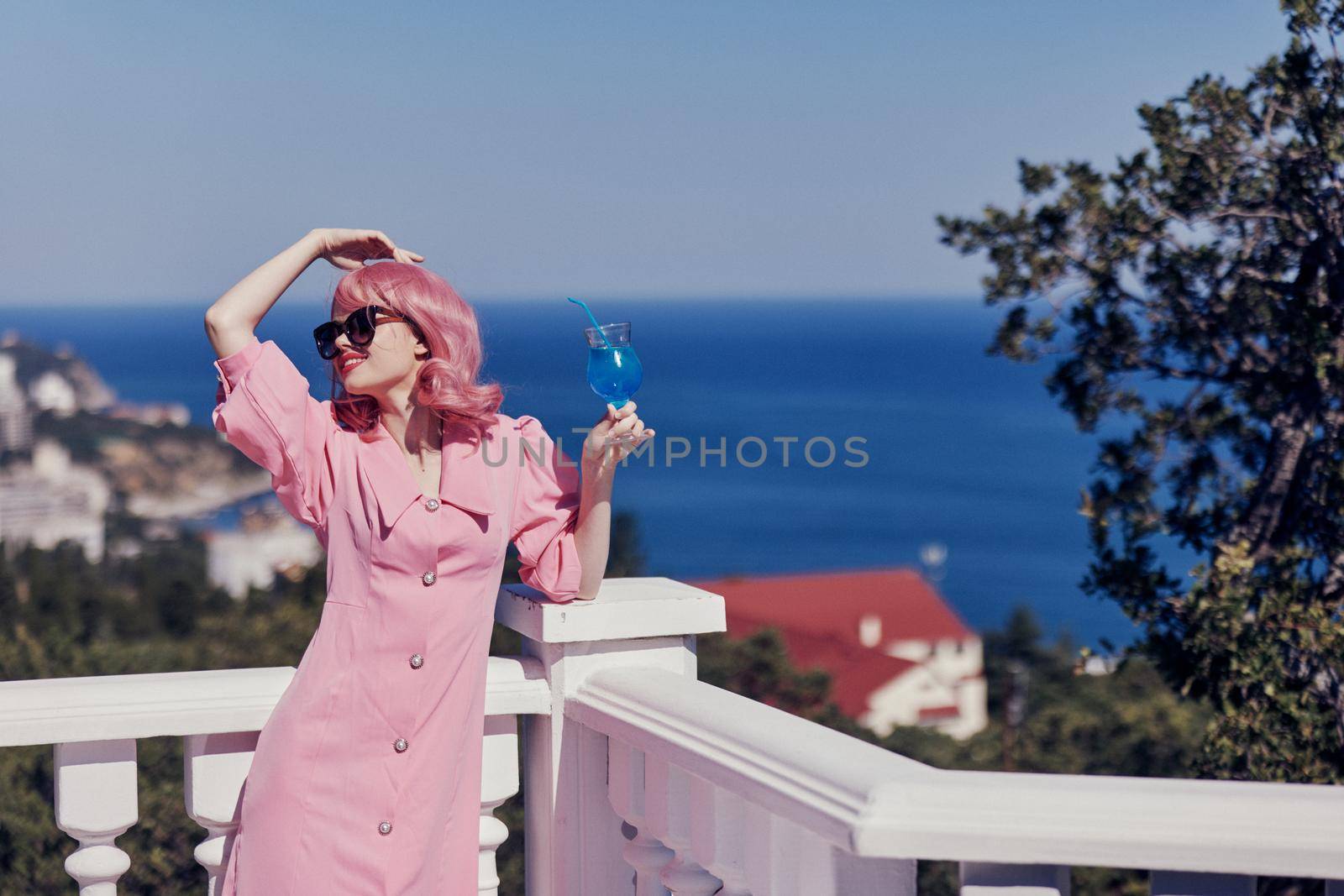 glamorous woman drinking a cocktail on the terrace Relaxation concept. High quality photo