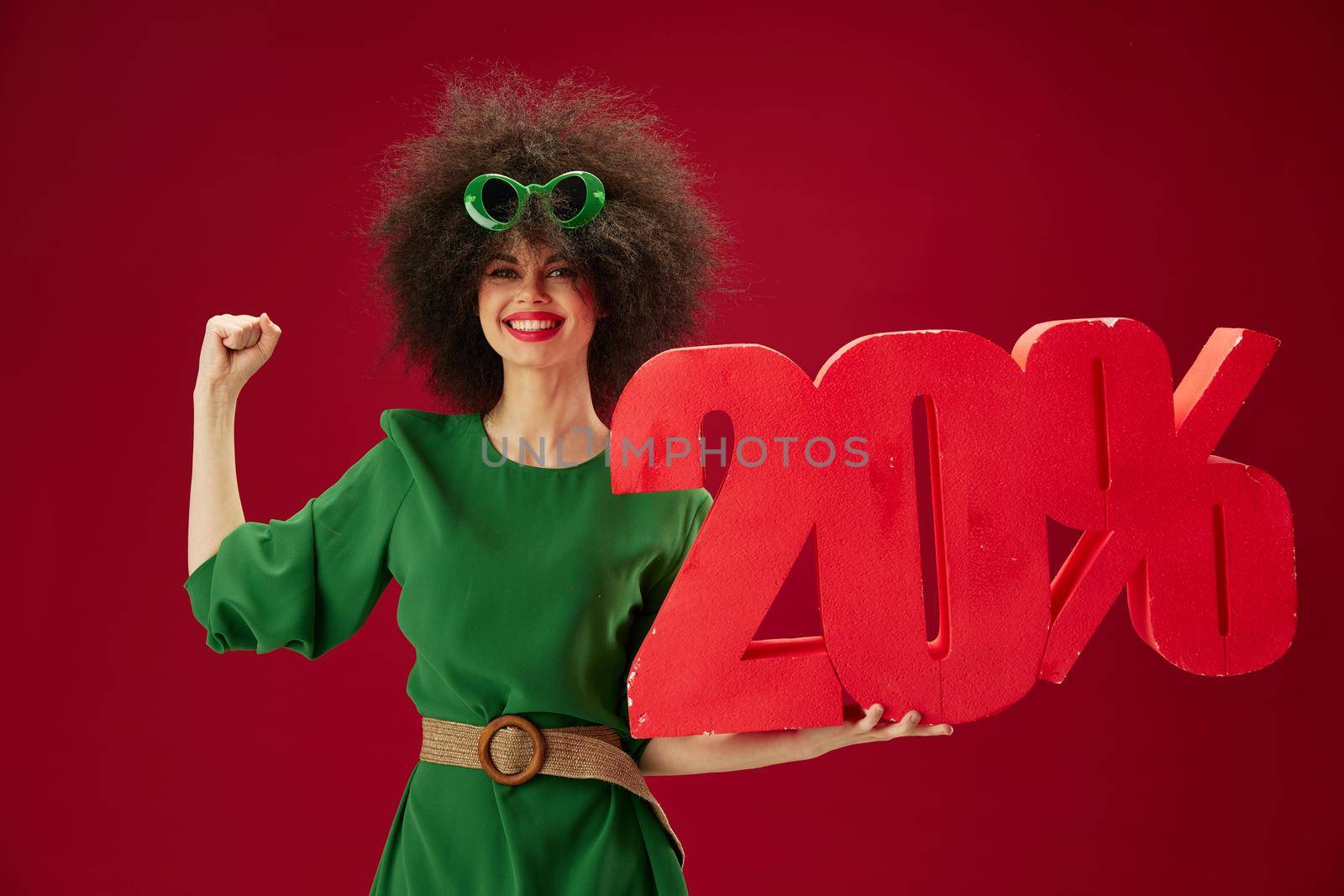 Portrait of a charming lady holding red twenty percent discount advertising color background unaltered by SHOTPRIME