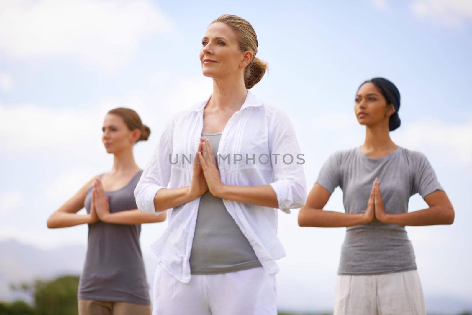 Women doing yoga outdoors.