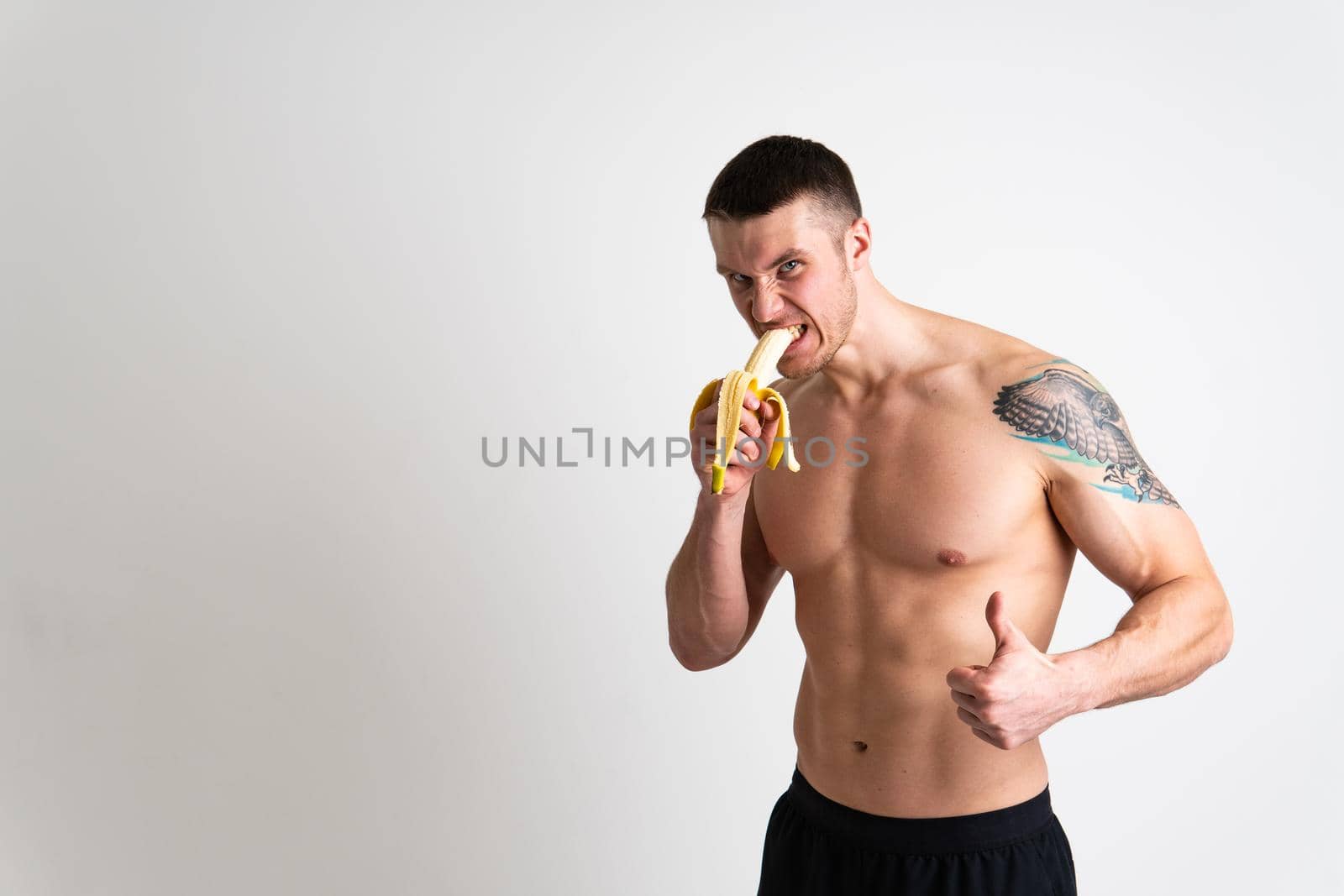 Man holds apples in fitness white background isolated man health, handsome fruit strong athlete, caucasian person. Exercise energy bodybuilder chest