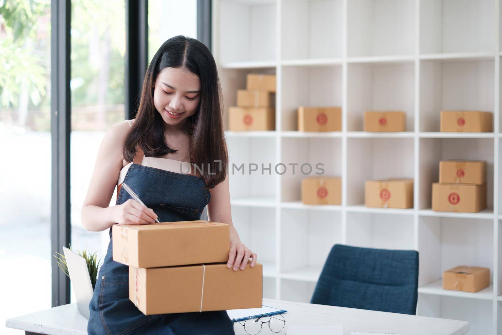 Asian small business owner working at home office. Business retail market and online sell marketing delivery, SME e-commerce concept. by itchaznong