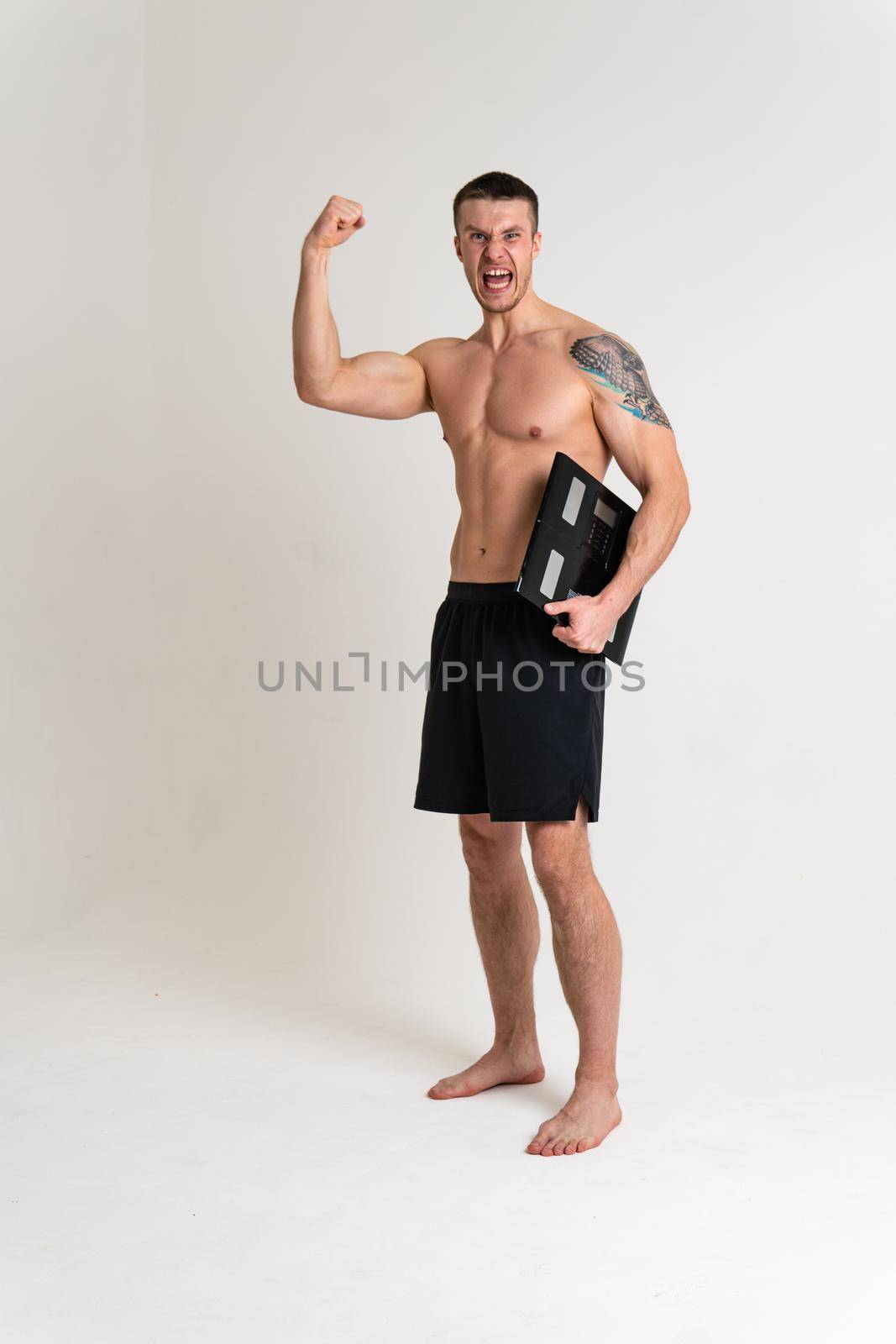 Man with weights health pondered, health and sports on a white background back sore cramp sick man background stress, illness holding. Tension lumbar lower suffer attractive