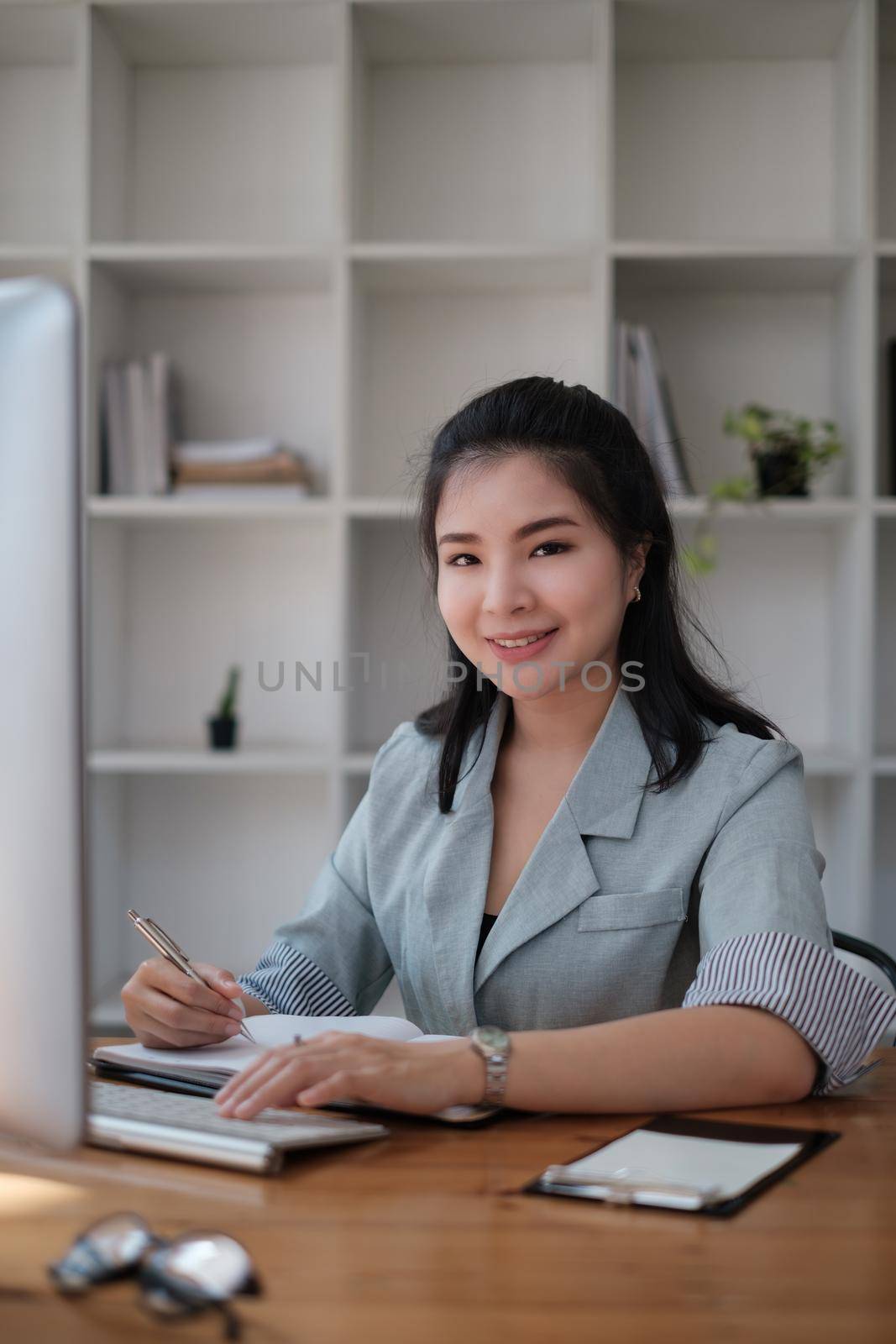 Asian business woman having video call with business team to consult about business plan of company. Online team meeting video conference. by itchaznong