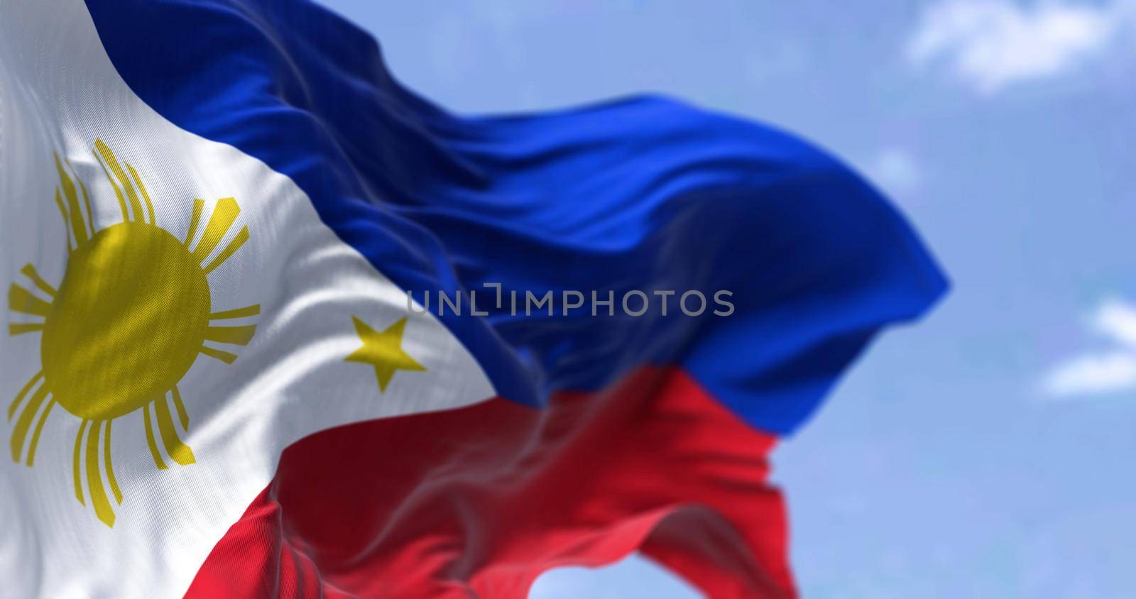 Detail of the national flag of the Philippines waving in the wind on a clear day. The Philippines is an archipelagic country in Southeast Asia. Selective focus.