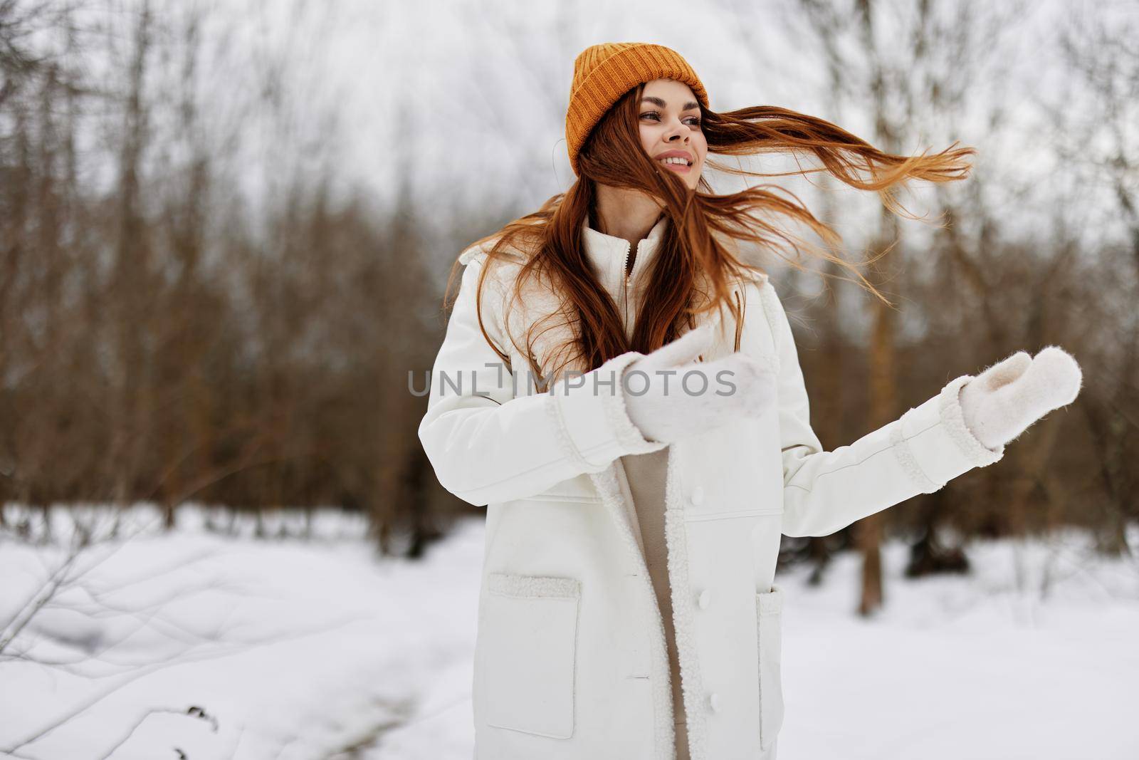portrait of a woman in winter clothes in a hat fun winter landscape fresh air by SHOTPRIME