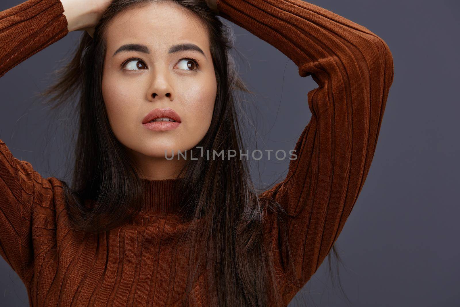 young woman brown sweater glamor posing smile fashion studio model. High quality photo