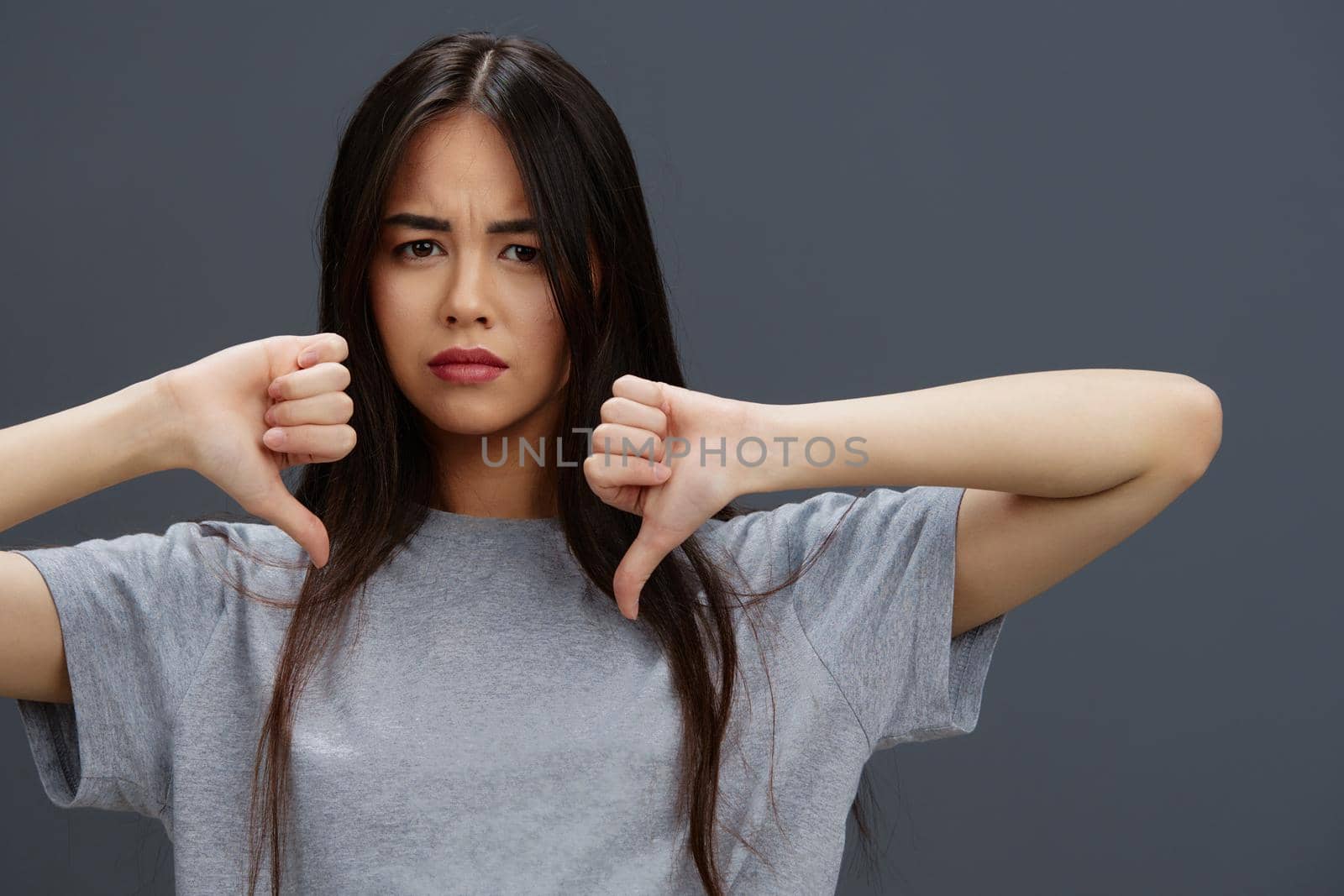 Brunette in a t-shirt and jeans posing Youth style isolated background. High quality photo