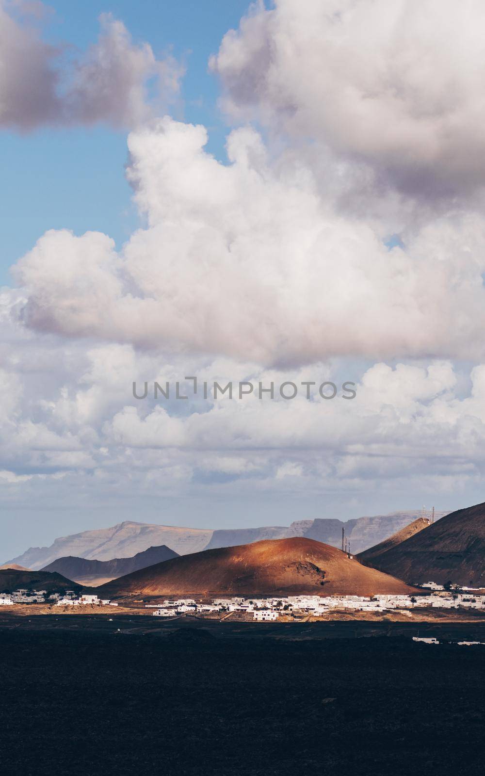 Amazing panoramic landscape of volcano craters in Timanfaya national park. Popular touristic attraction in Lanzarote island, Canary islans, Spain. Artistic picture. Beauty world. Travel concept