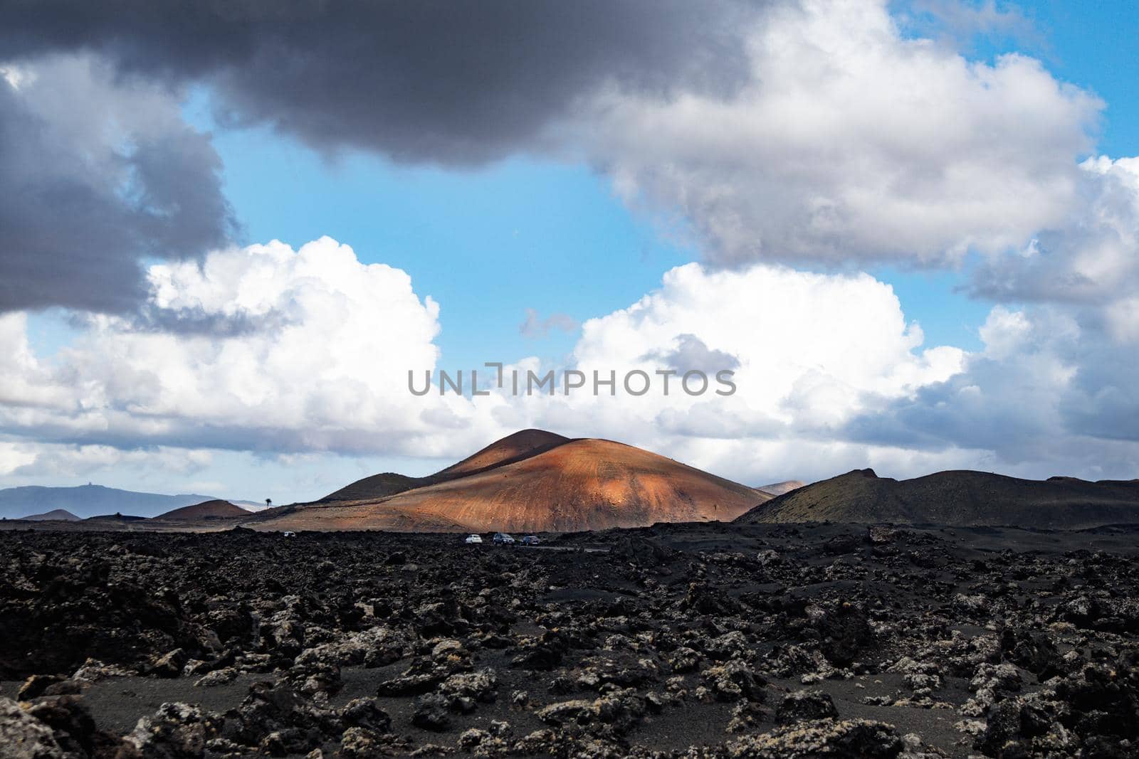 Amazing panoramic landscape of volcano craters in Timanfaya national park. Popular touristic attraction in Lanzarote island, Canary islans, Spain. Artistic picture. Beauty world. Travel concept. by kasto