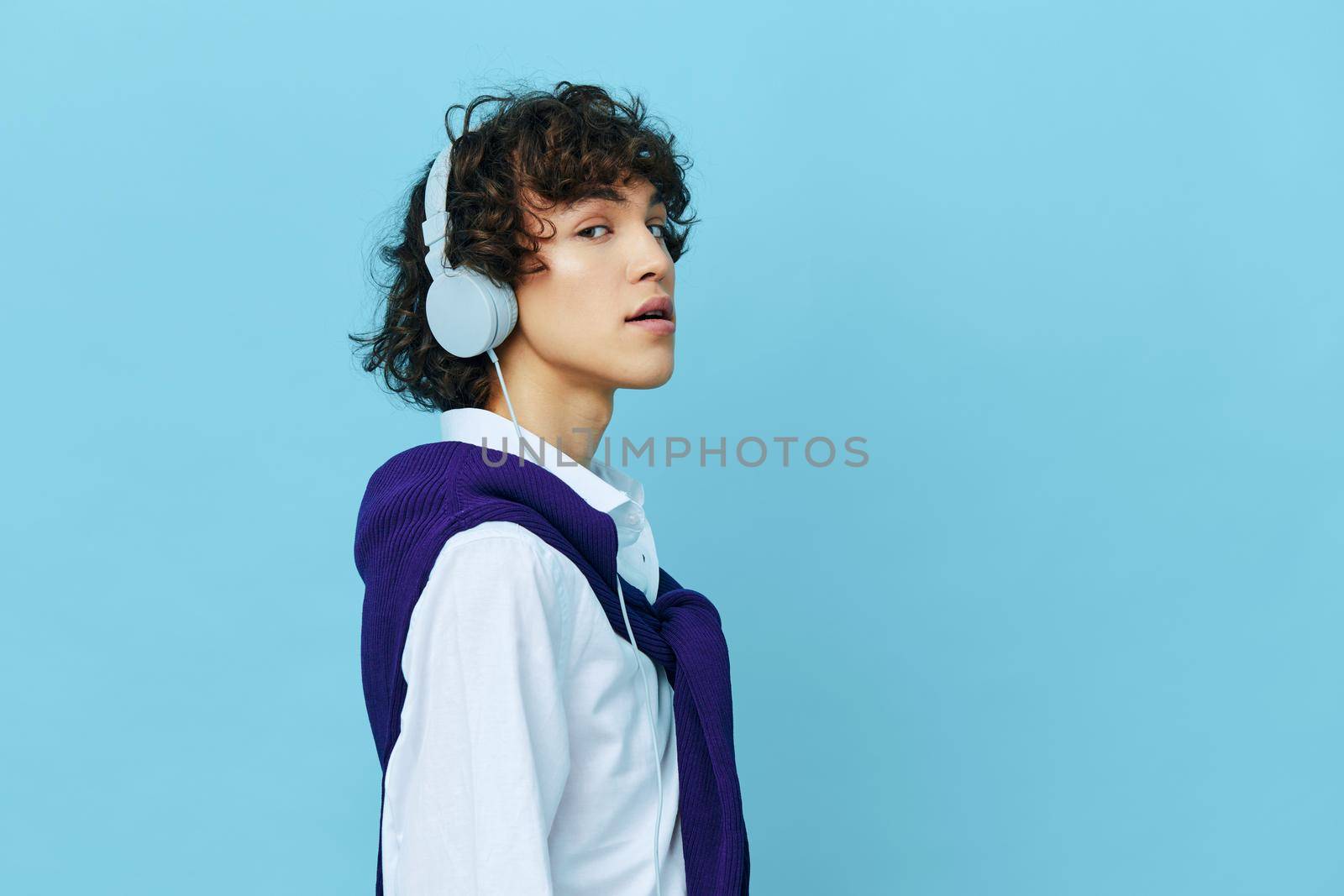 guy technology headphones in a white shirt with sweater Lifestyle school. High quality photo