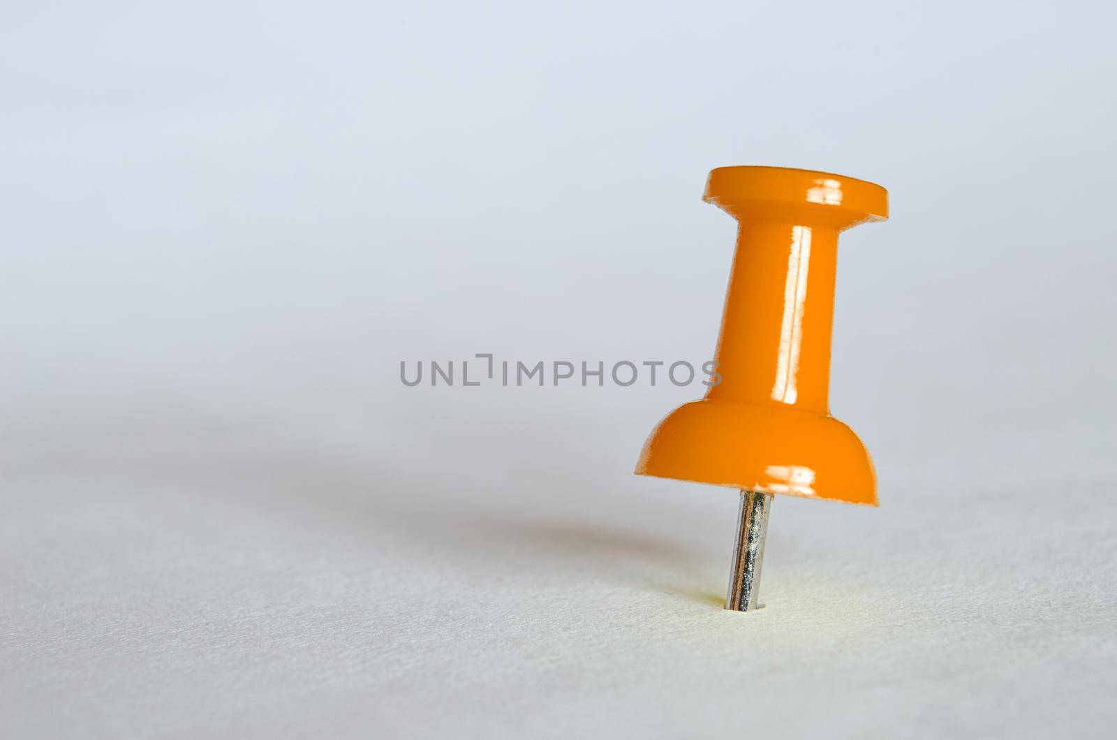 Orange push pin. Closeup photography of orange thumbtack.