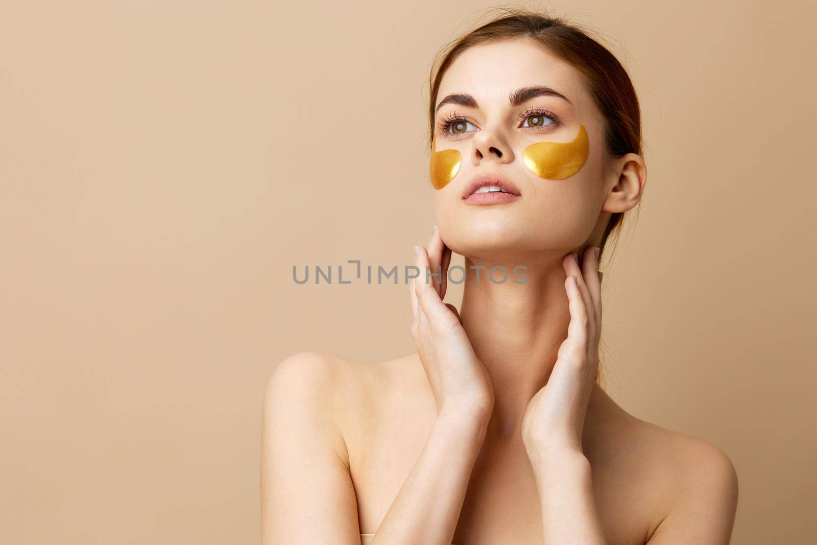 portrait woman golden patches clean skin smile posing beige background. High quality photo