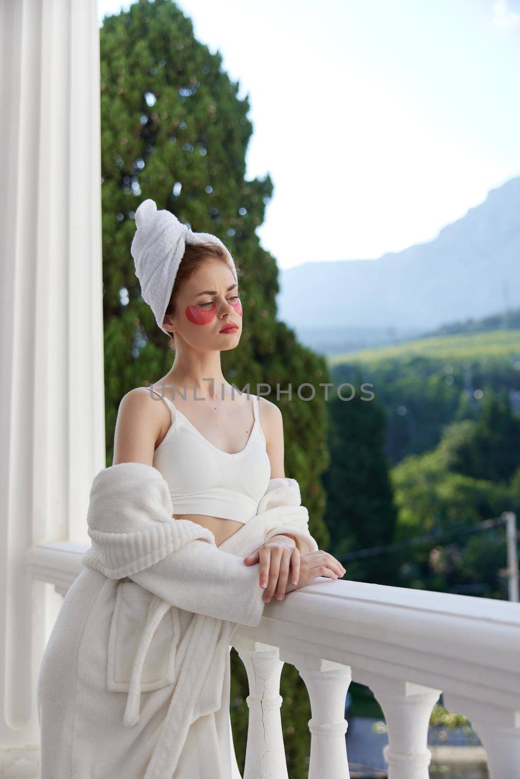 Woman in a bathrobe having beauty under-eye patch treatment Perfect sunny morning by SHOTPRIME