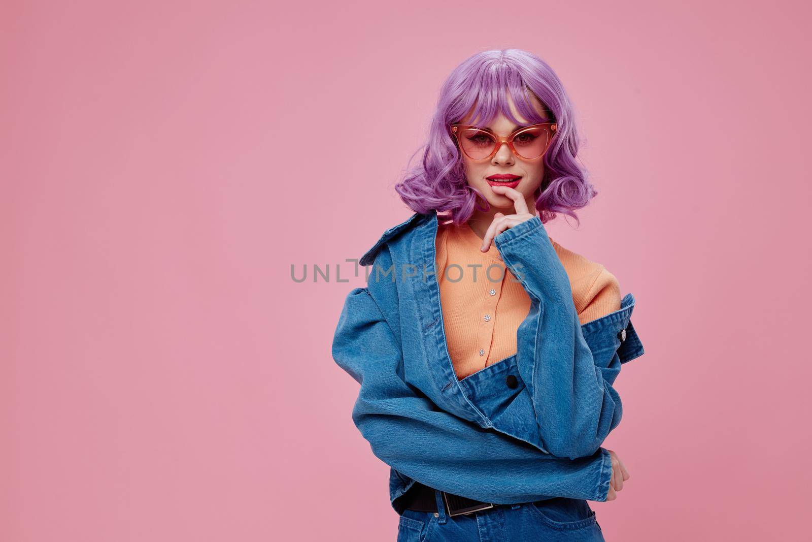 Portrait of a charming lady purple hairstyle red lips denim jacket fun color background unaltered. High quality photo