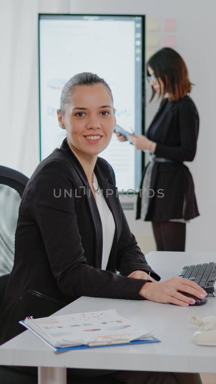 Businesswoman working on computer with data charts by DCStudio