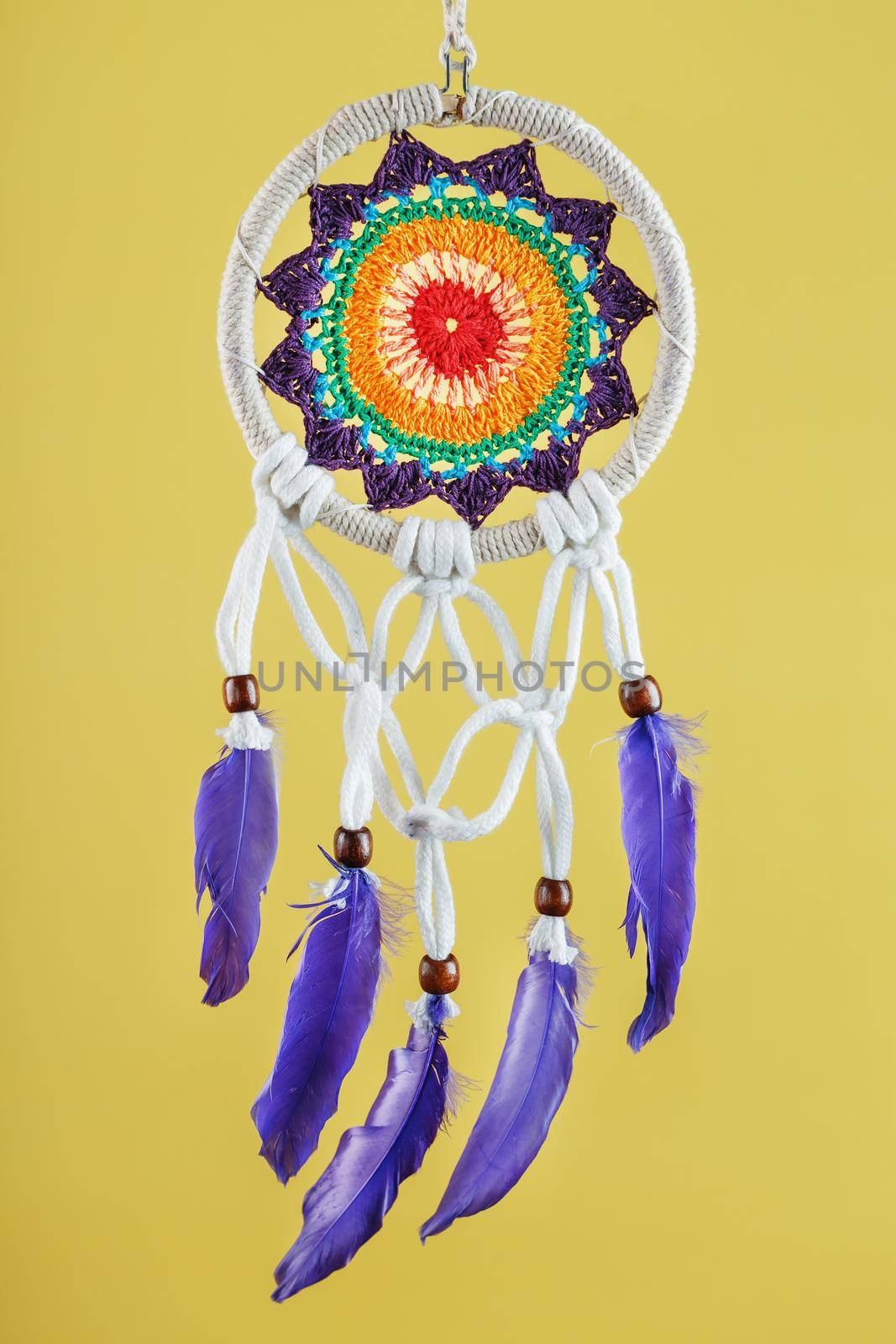Handmade amulet dream catcher on a yellow background, protecting the sleeper by AlexGrec