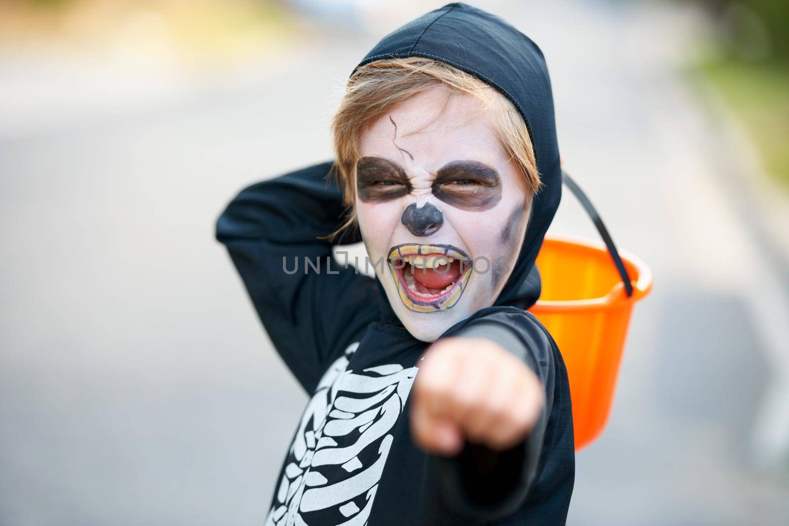 Little boy dressed up as a skeleton fro Halloween trying to scare you.