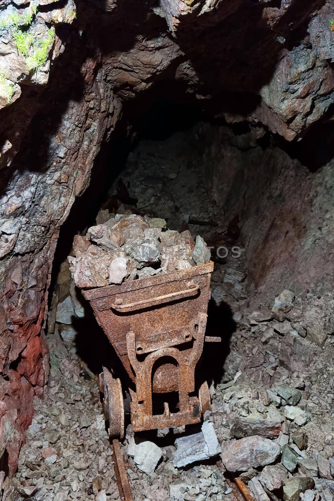 Old abandoned ore mine. Rusty trolley. Extraction of minerals