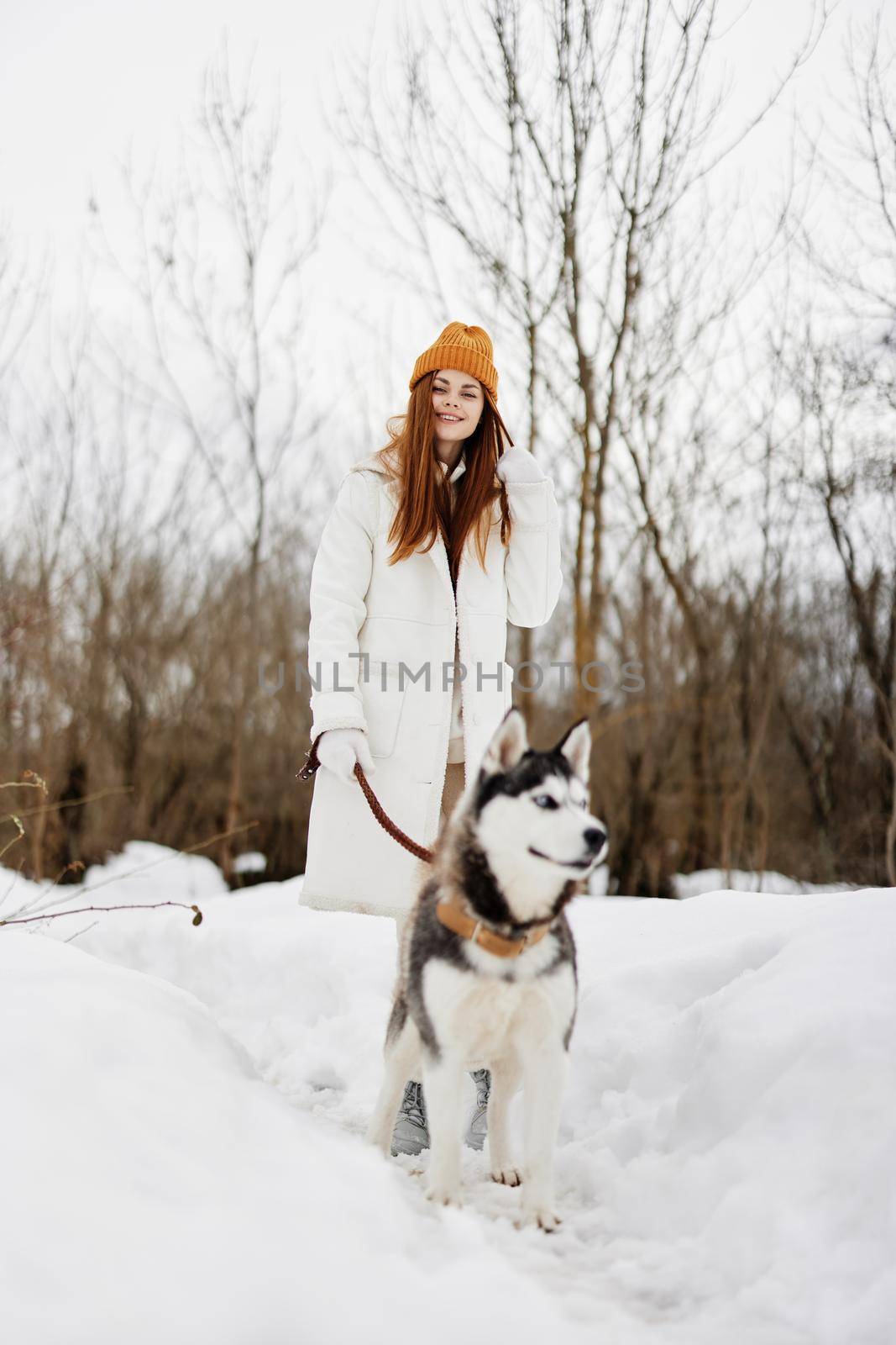 woman winter clothes walking the dog in the snow Lifestyle. High quality photo